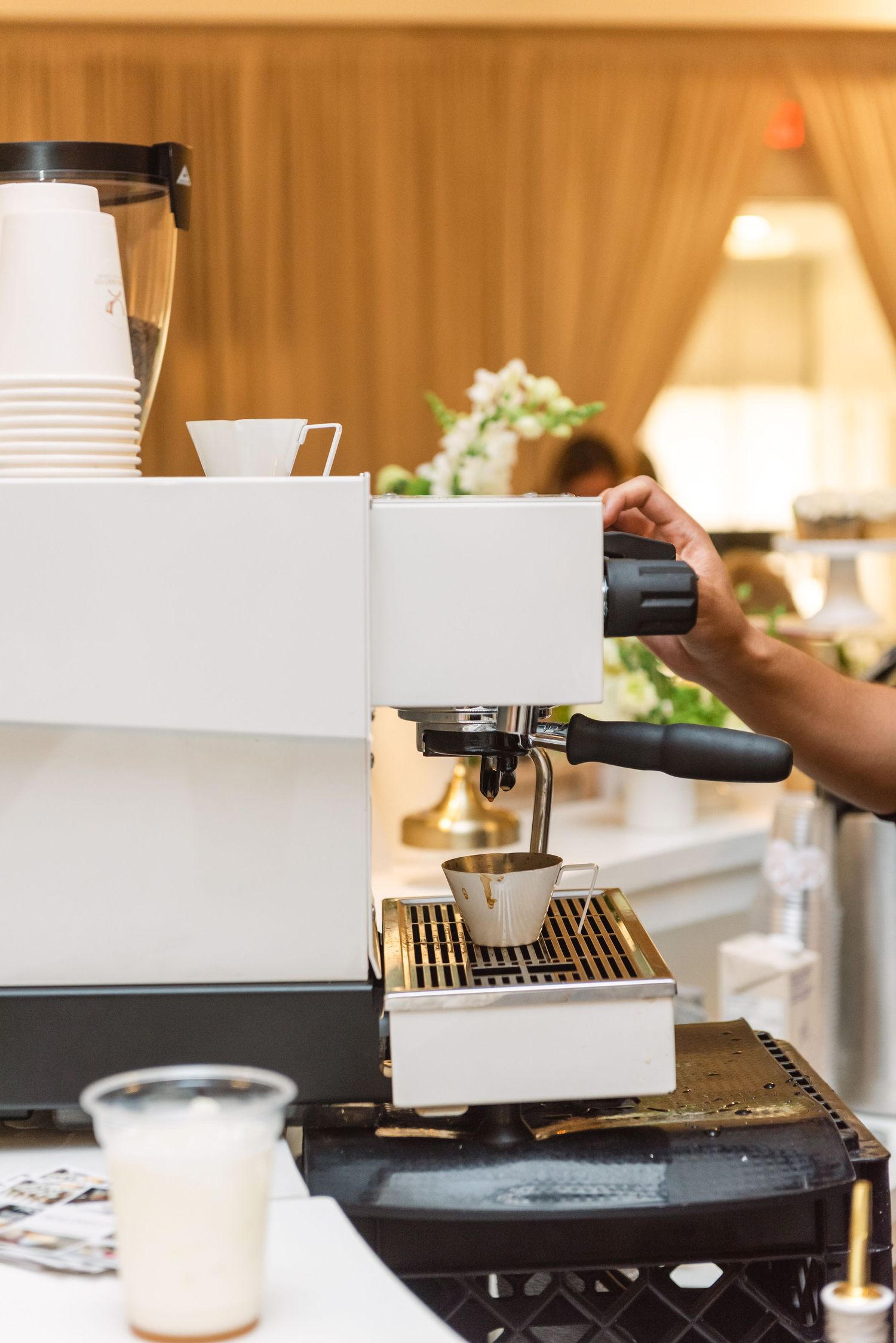 Coffee machine and barista equipment setup at an event counter.