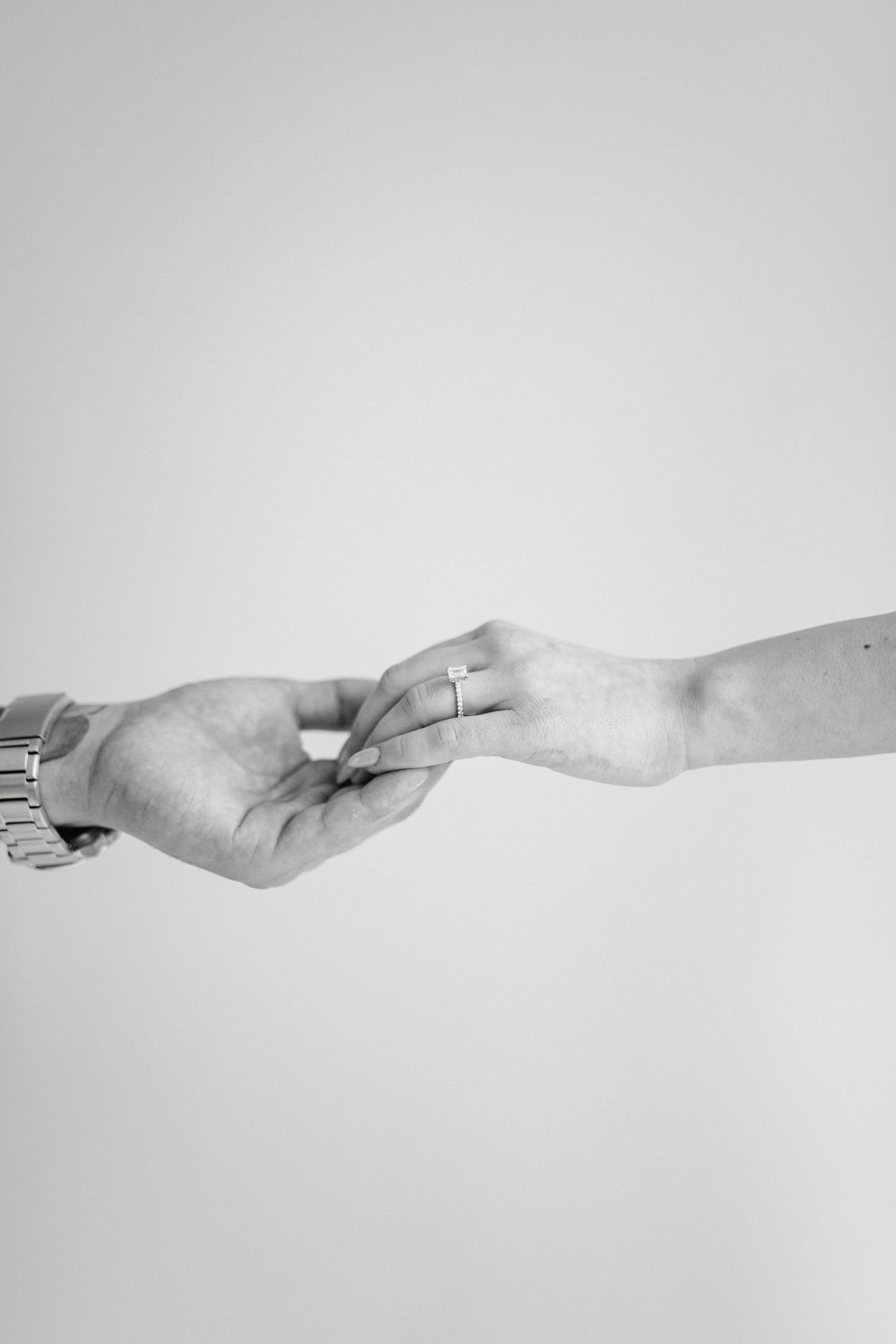 Minimalist black and white photo series showing connected hands forming a horizontal line.