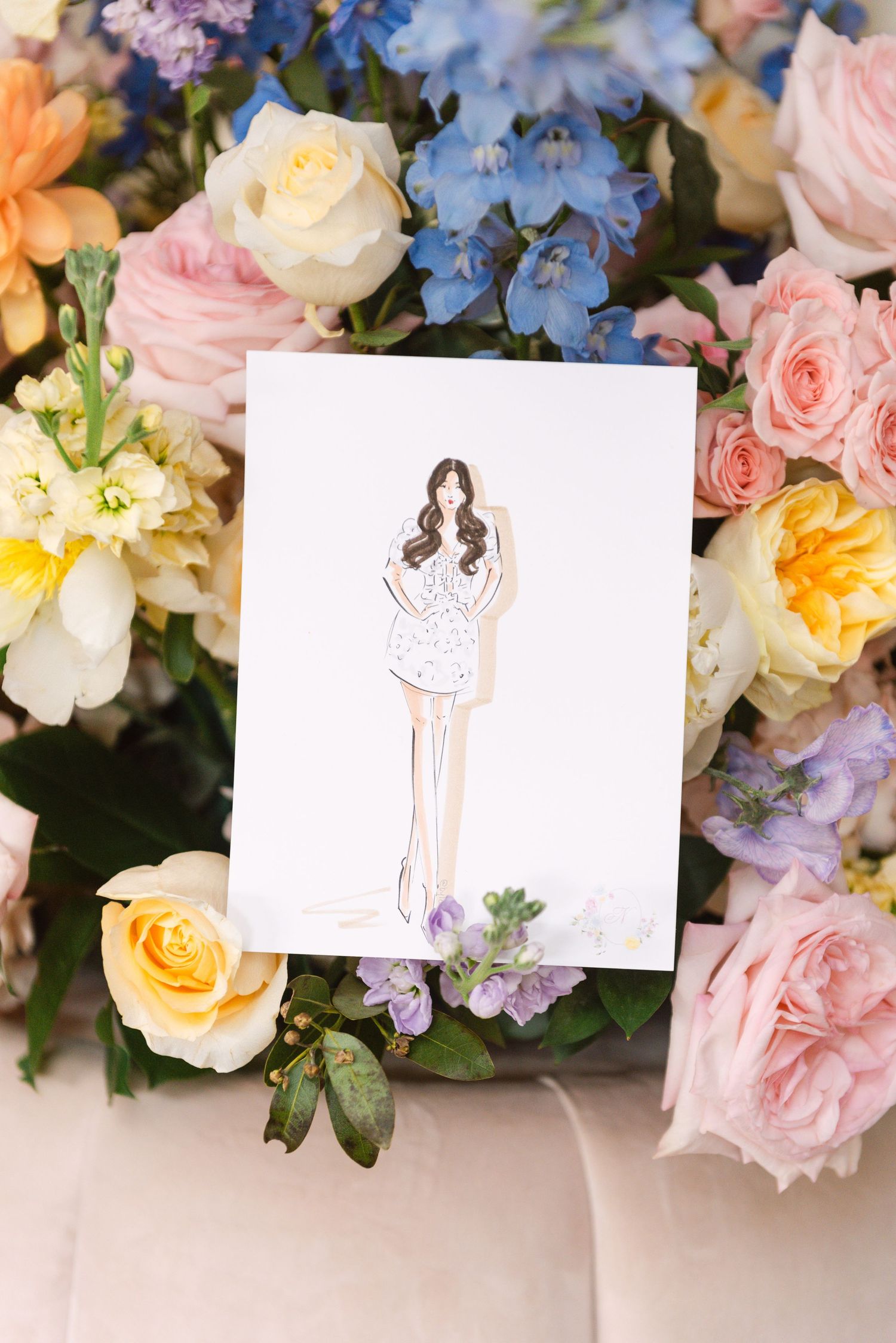 Fashion illustration of a bride in a white dress surrounded by colorful pastel wedding flowers.