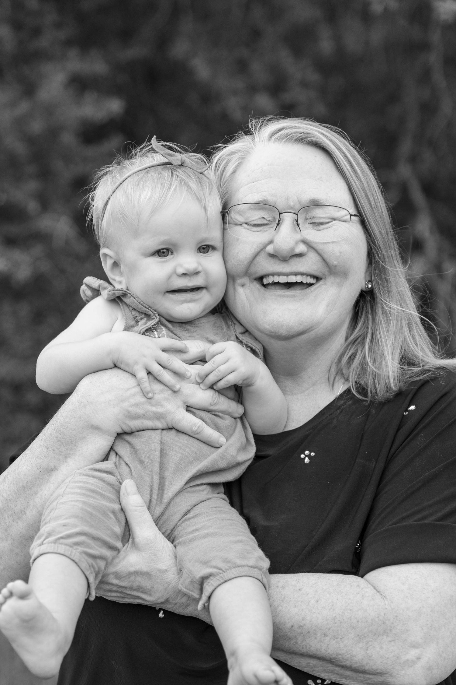 A heartwarming series of black and white photos showing tender moments between an adult and baby.