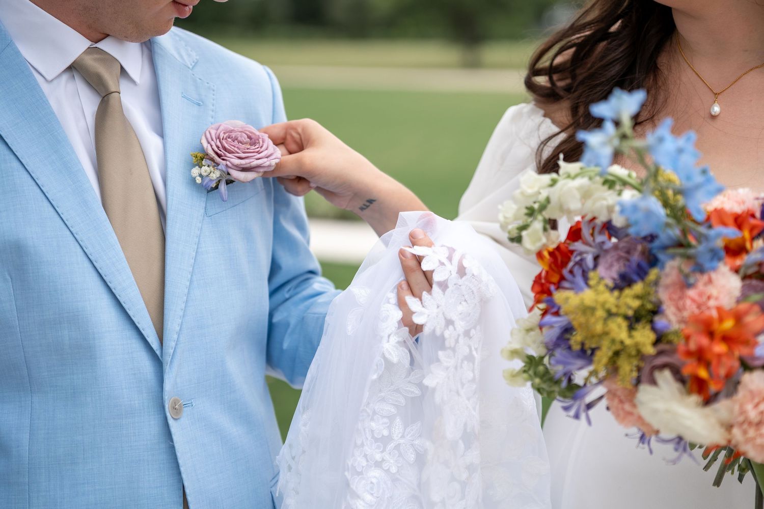 Colorful wildflower bouquets add vibrant touches to an outdoor wedding celebration.