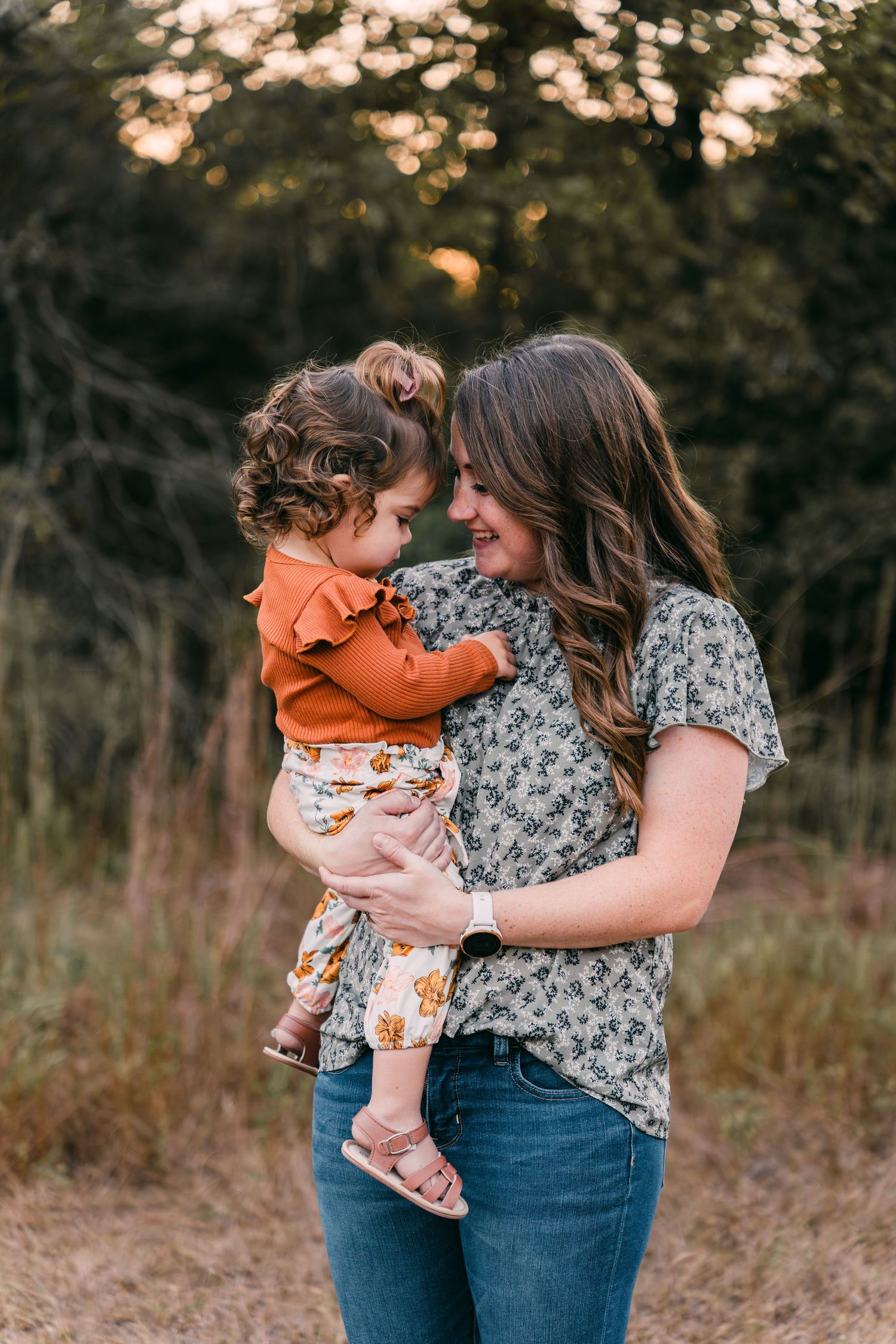 Mother and child sharing tender moments during outdoor family photo session.