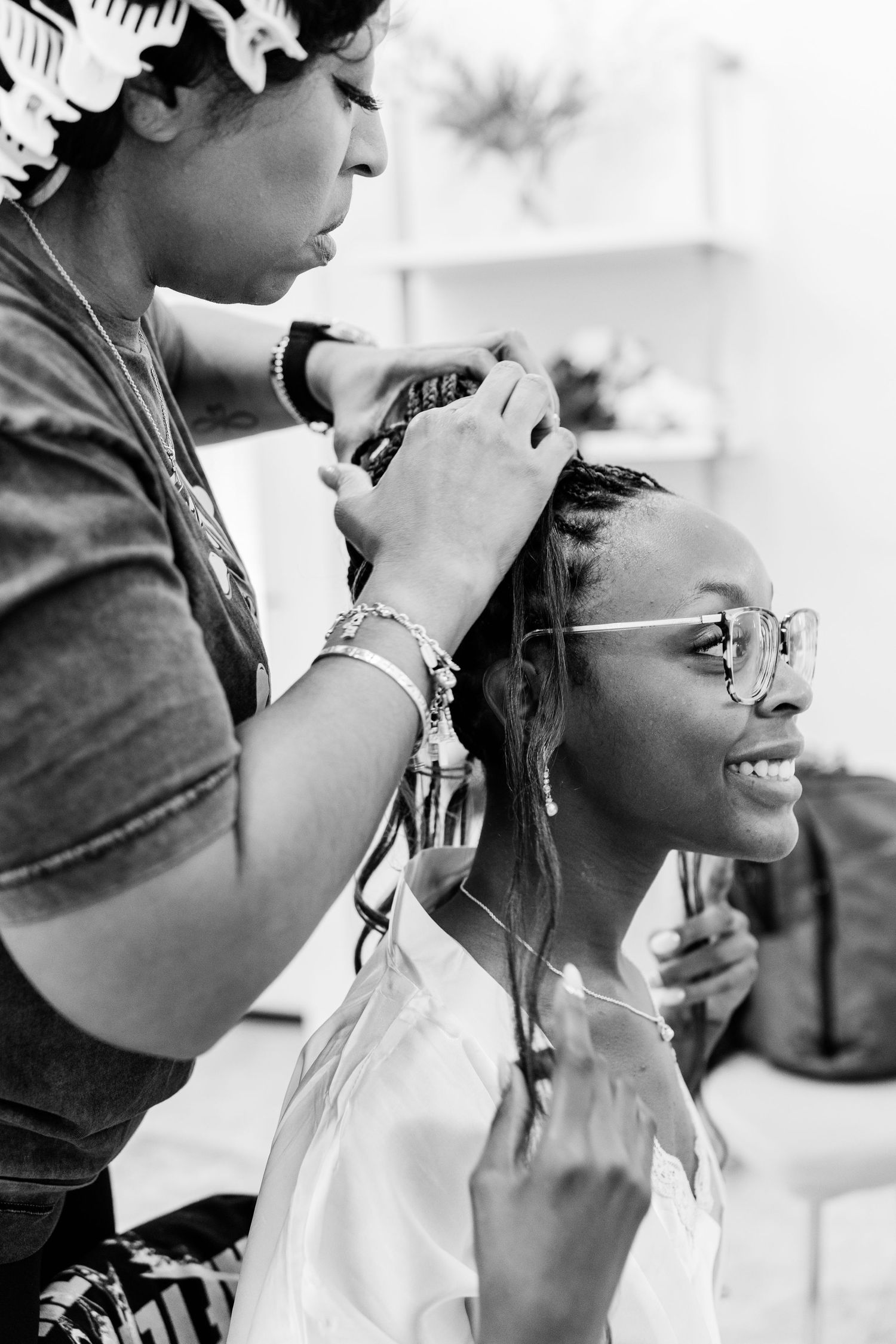 Black and white photo series showing close-up shots of guests enjoying drinks at a wedding celebration.