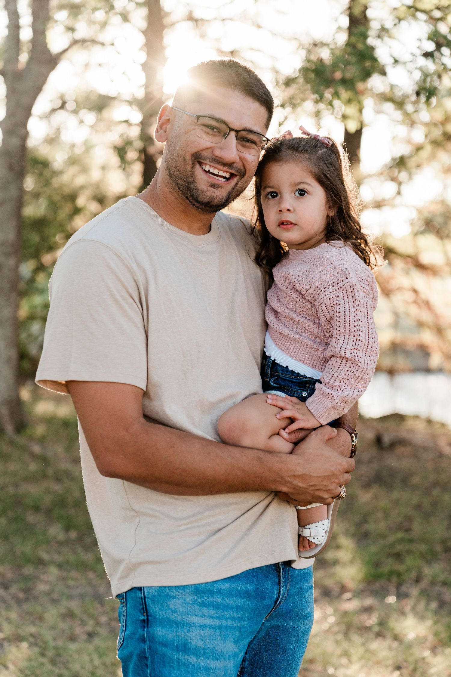 Sweet outdoor family moment captured in warm sunset lighting.