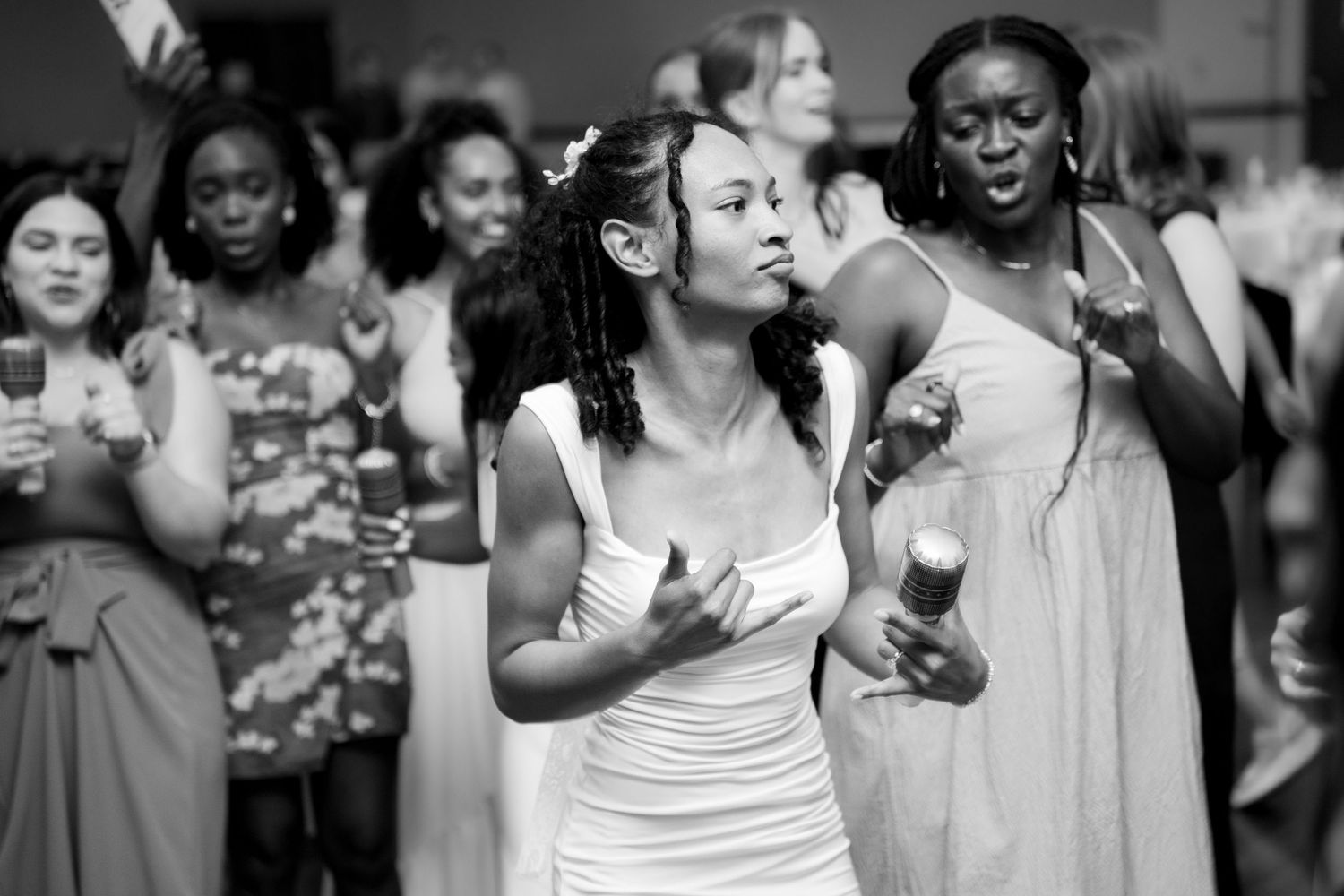 Wedding guests dancing and celebrating at reception party.