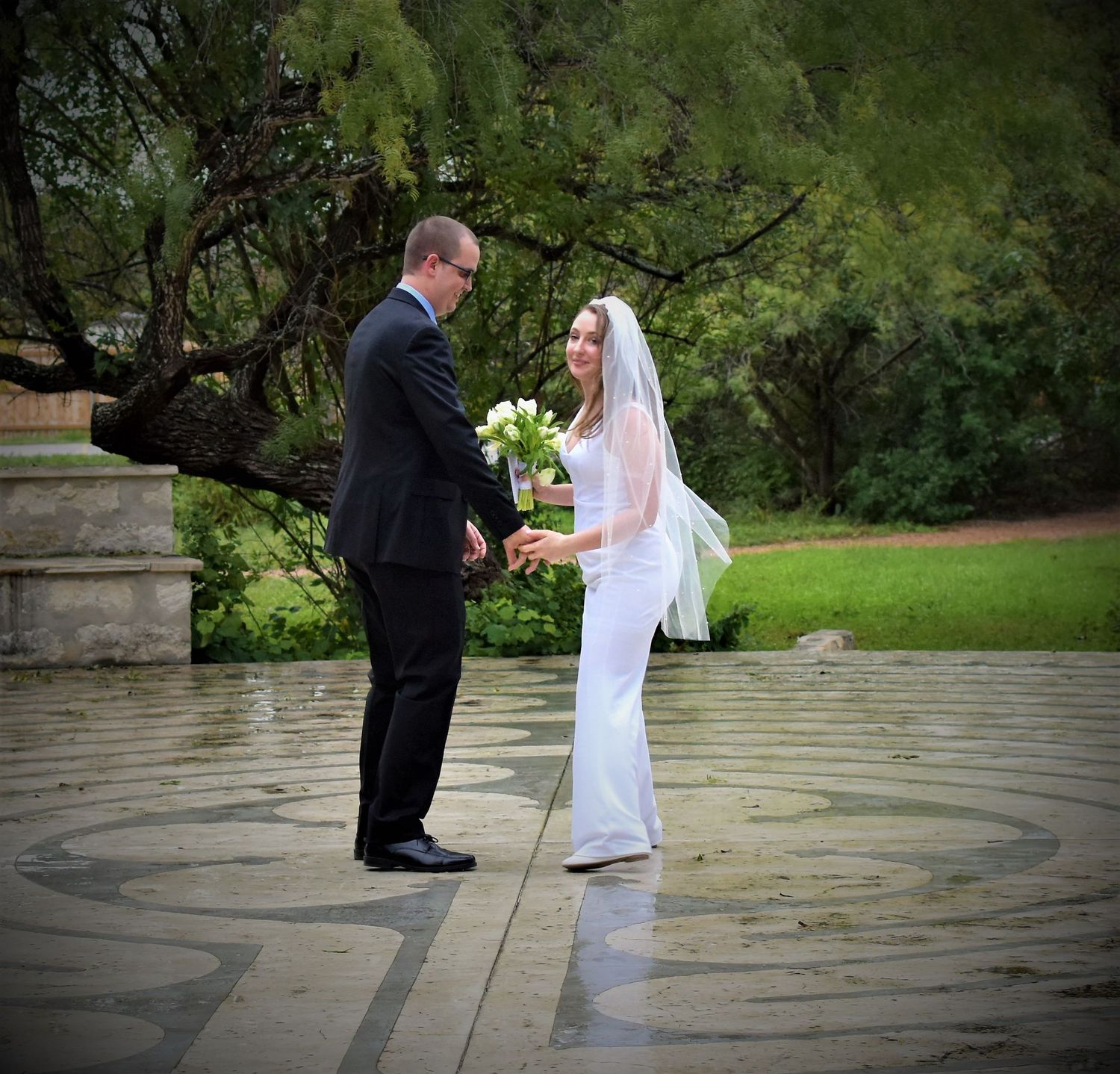 Outdoor wedding ceremony sequence showing couple exchanging rings on stone patio. San Antonio wedding photography