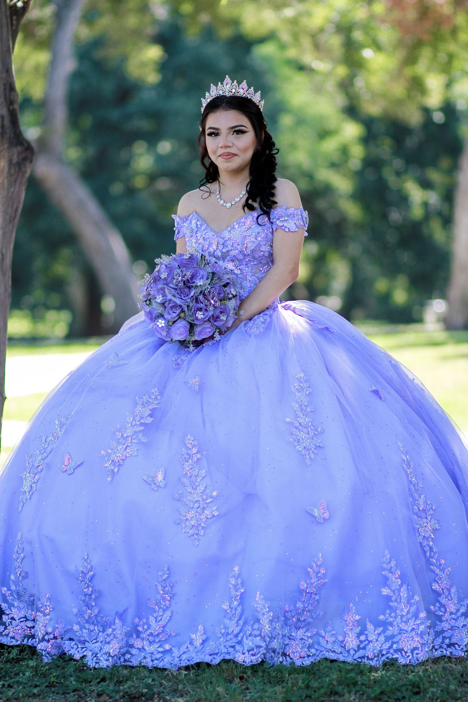 A young lady in her quinceañera lavender dress with lace details and matching bouquet photographed at Brackenridge park in San Antonio, Tx.