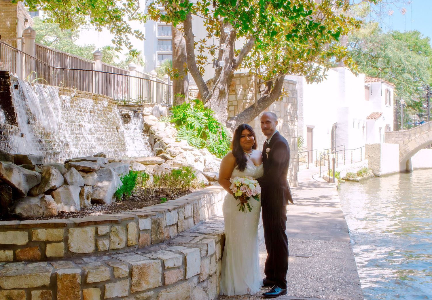Stone pathway along Riverwalk in San Antonio, Texas with romantic couple in distance. Wedding photography session