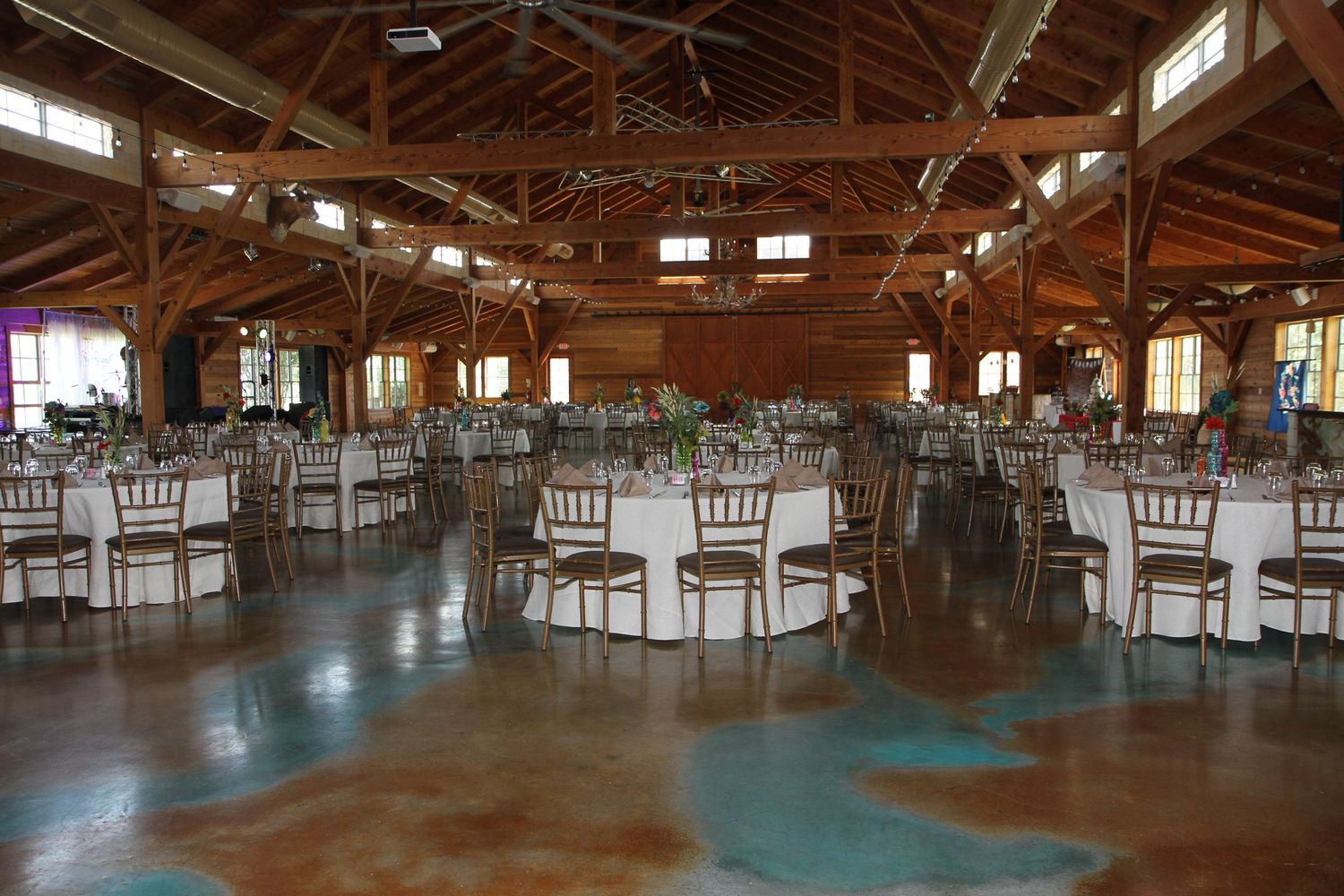 Panoramic view of a rustic wooden reception at The Reserve at Dancing Elk venue with elegant table settings. San Antonio wedding photography