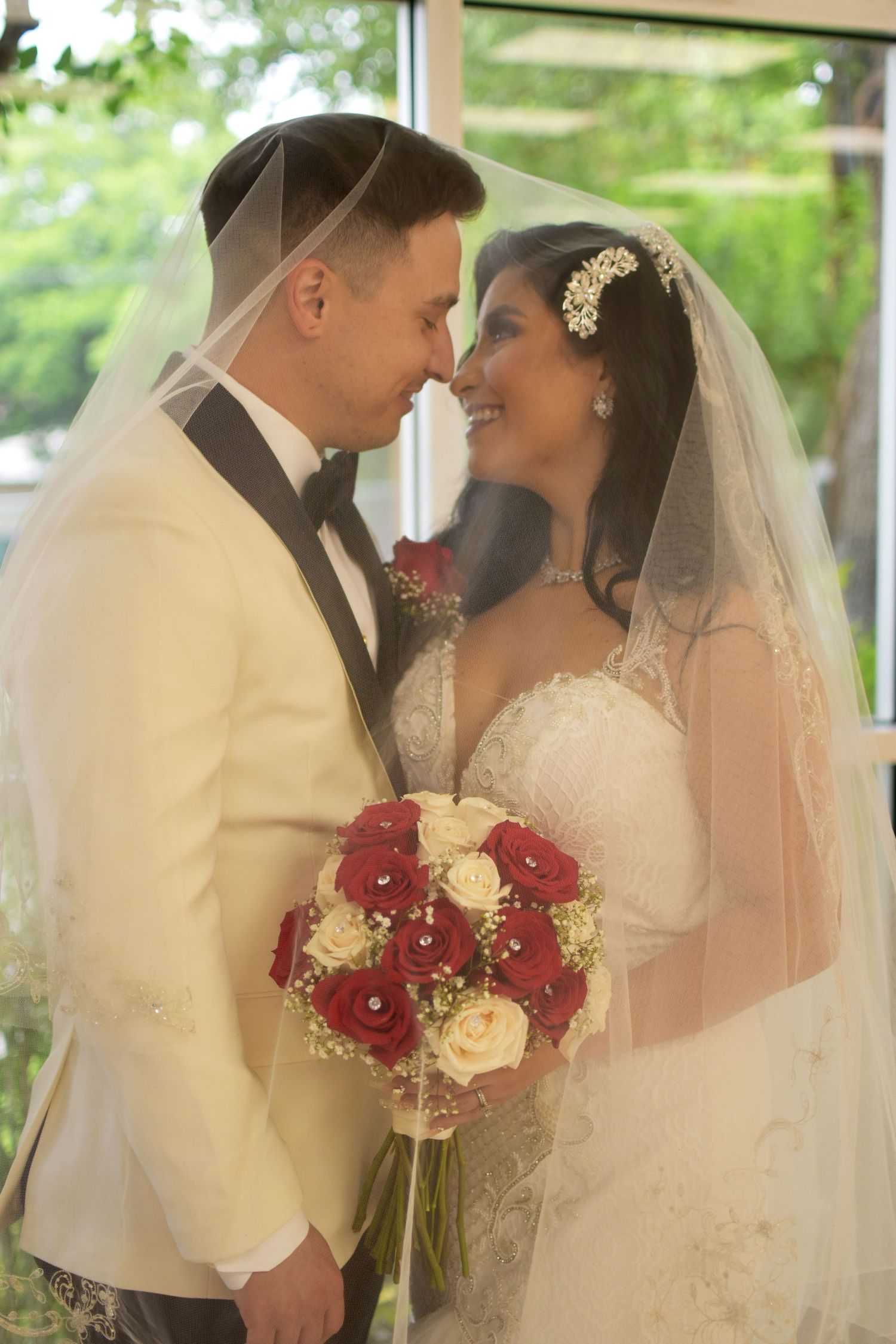 A romantic wedding sequence shows a bride and groom in white sharing tender moments with red and cream floral bouquet.