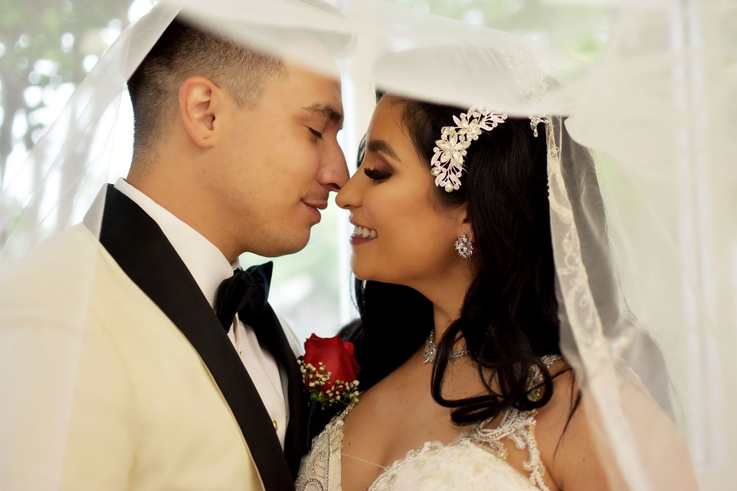 Intimate wedding portrait of couple under veil with red floral bouquet, San Antonio wedding photography