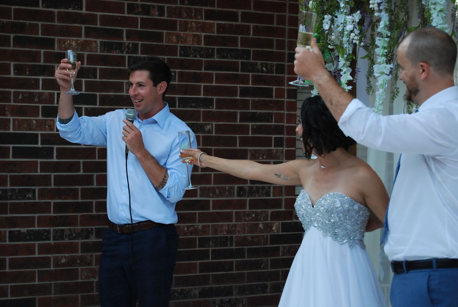 Wedding party celebrates with joyful toast at outdoor ceremony, San Antonio wedding photography
