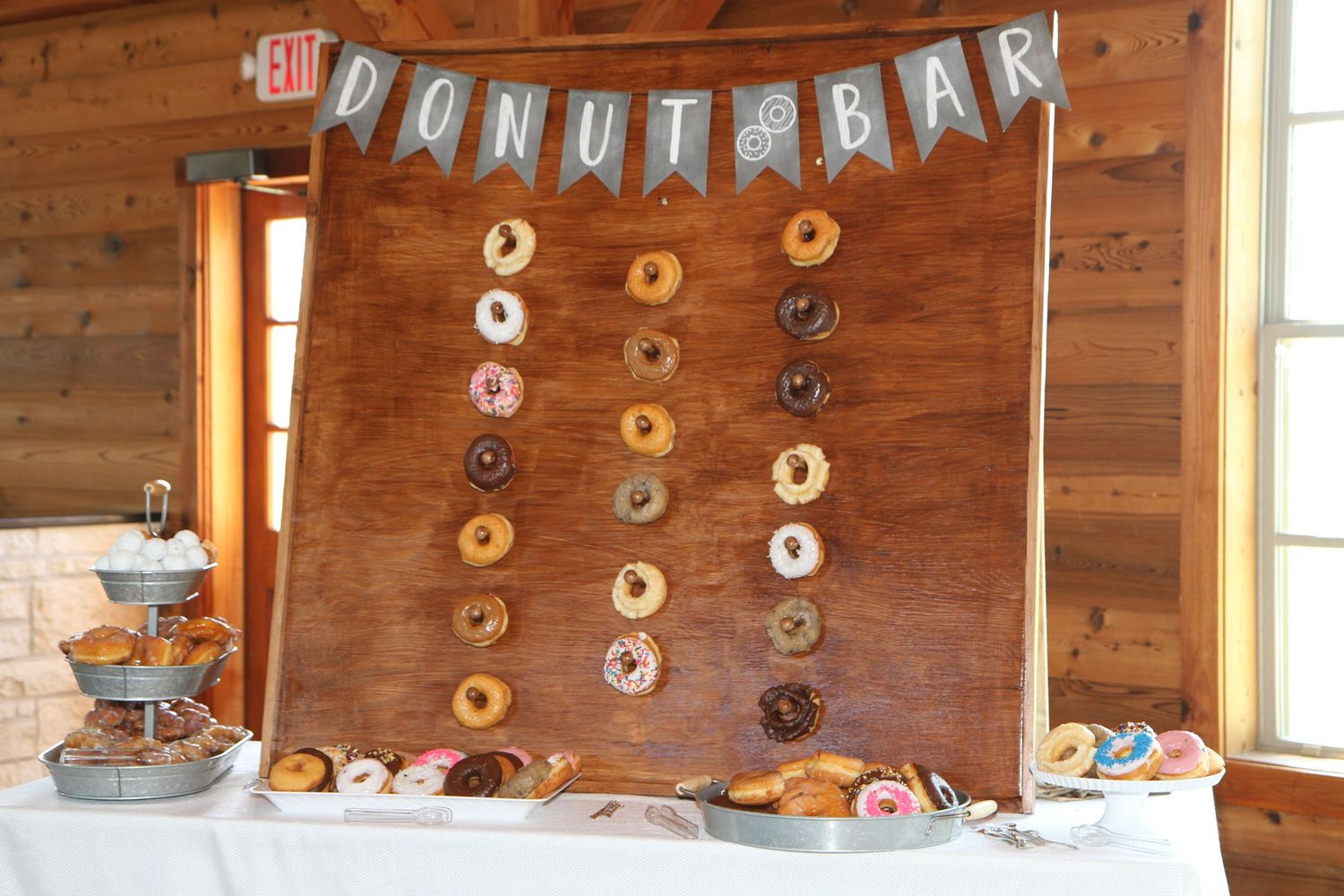 Rustic wooden wall decorated with donuts and bunting for a wedding reception. San Antonio wedding photography