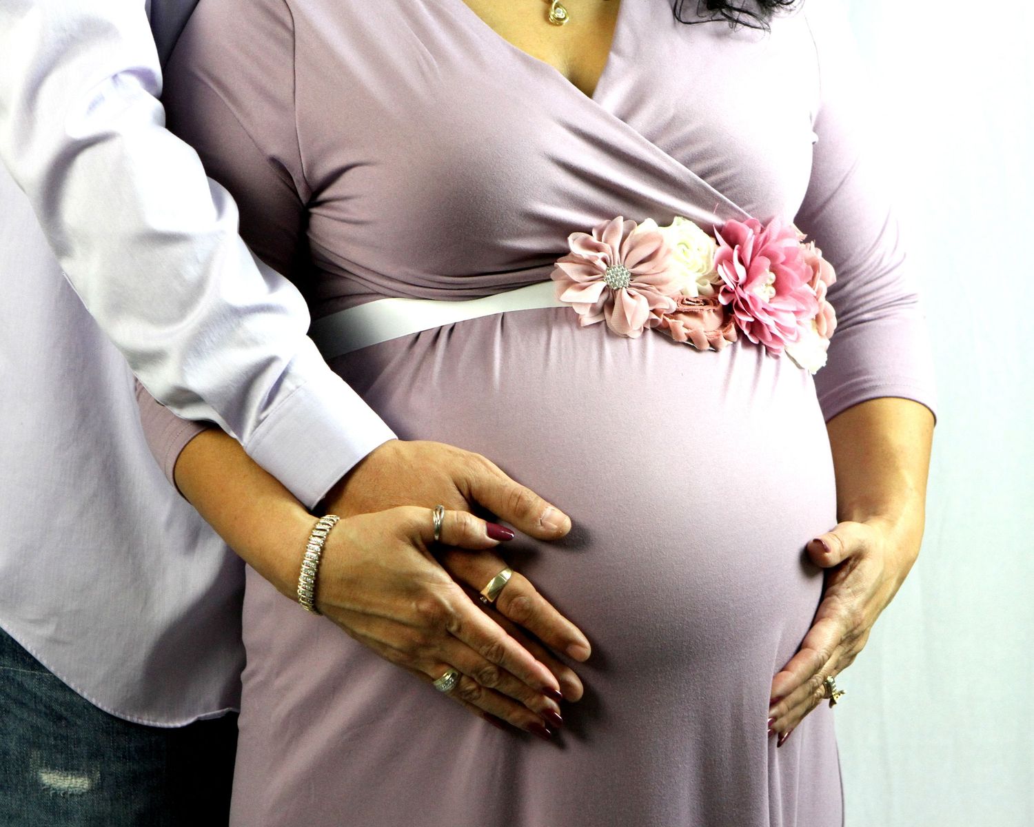 An intimate photo showing a pregnant woman's growing belly through the final stage of pregnancy at maternity session in San Antonio, Texas