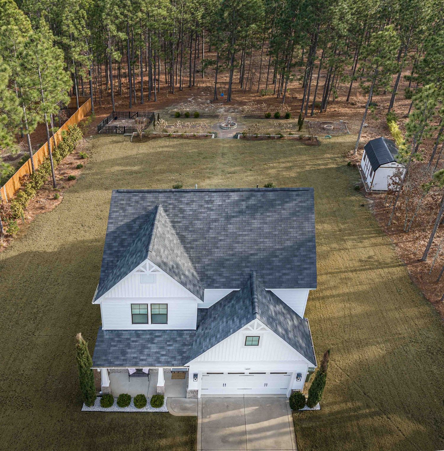 High-impact real estate visuals designed for digital marketing and engagement. Aerial Imagery of a roof and surrounding yard and landscape.