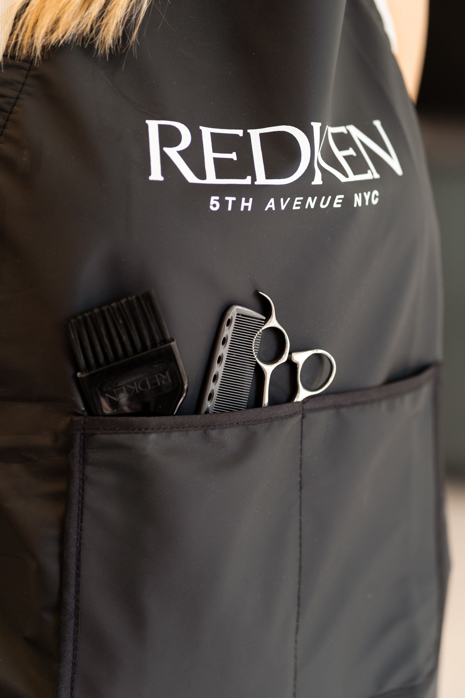Redken 5th Avenue NYC salon apron with comb and scissors in pocket.