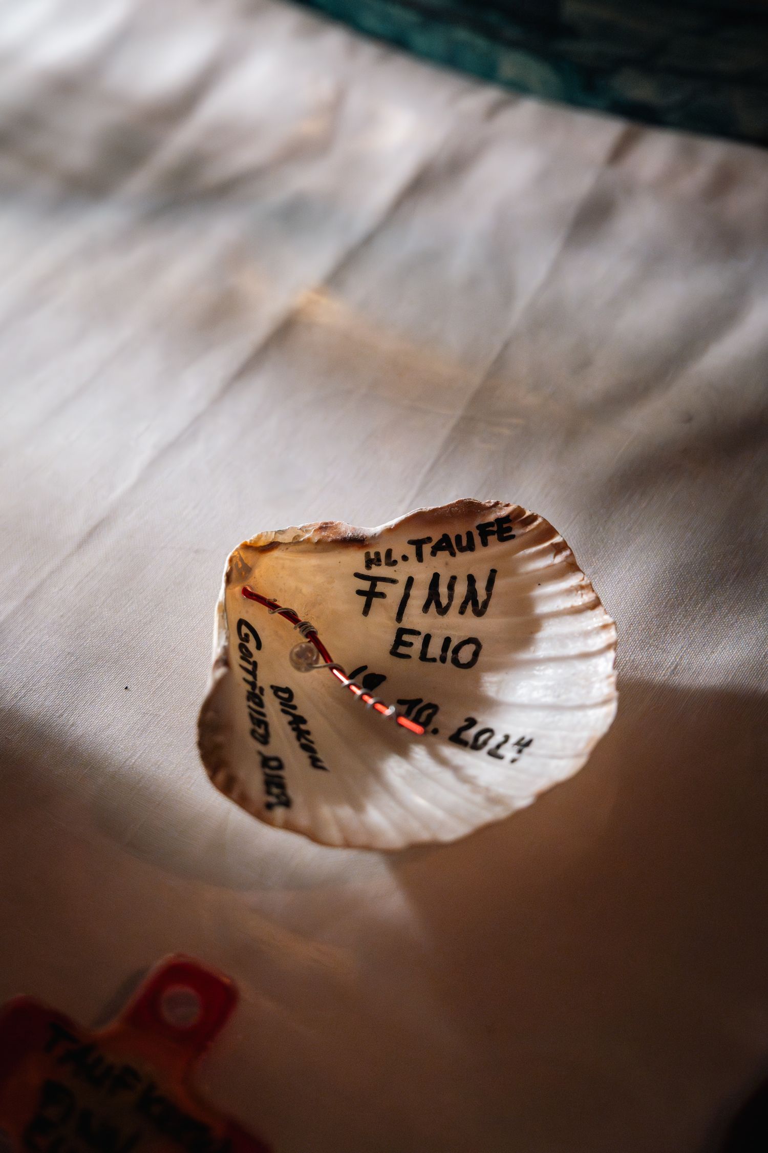 Seashell keepsake inscribed with name Finn Elio and date 10.10.2024 for baptism.