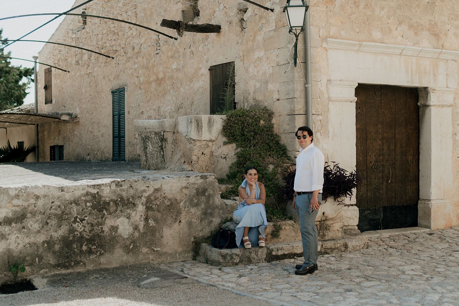 Panoramic view of a Mediterranean stone courtyard with traditional architecture and rustic charm.