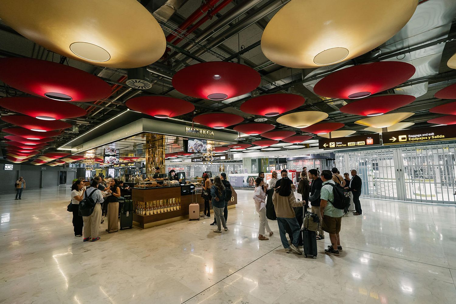 Modern shopping mall interior with red ceiling lights and reflective floors creating a dynamic atmosphere.