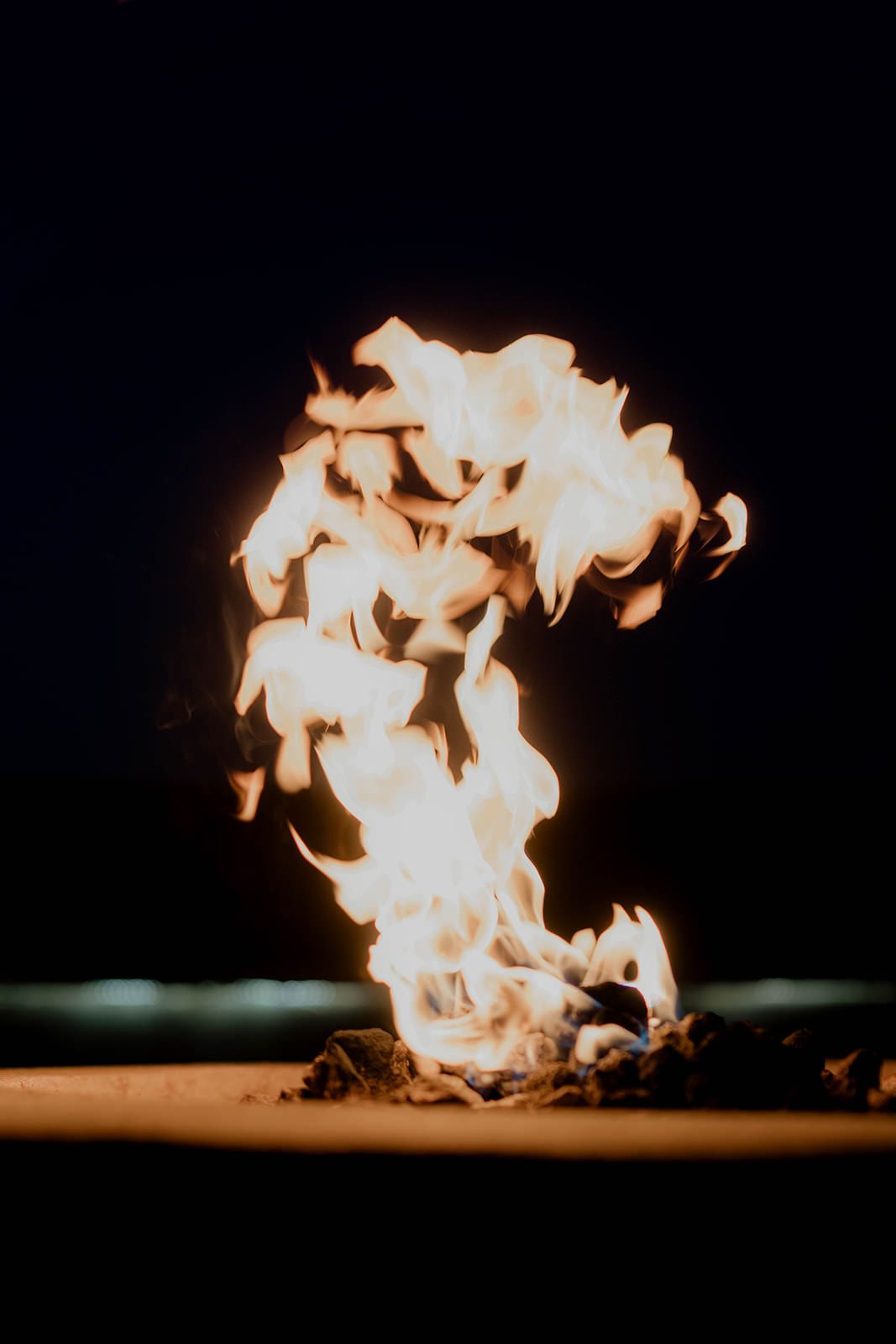 Bright flames dance against a dark background creating a dramatic atmosphere.