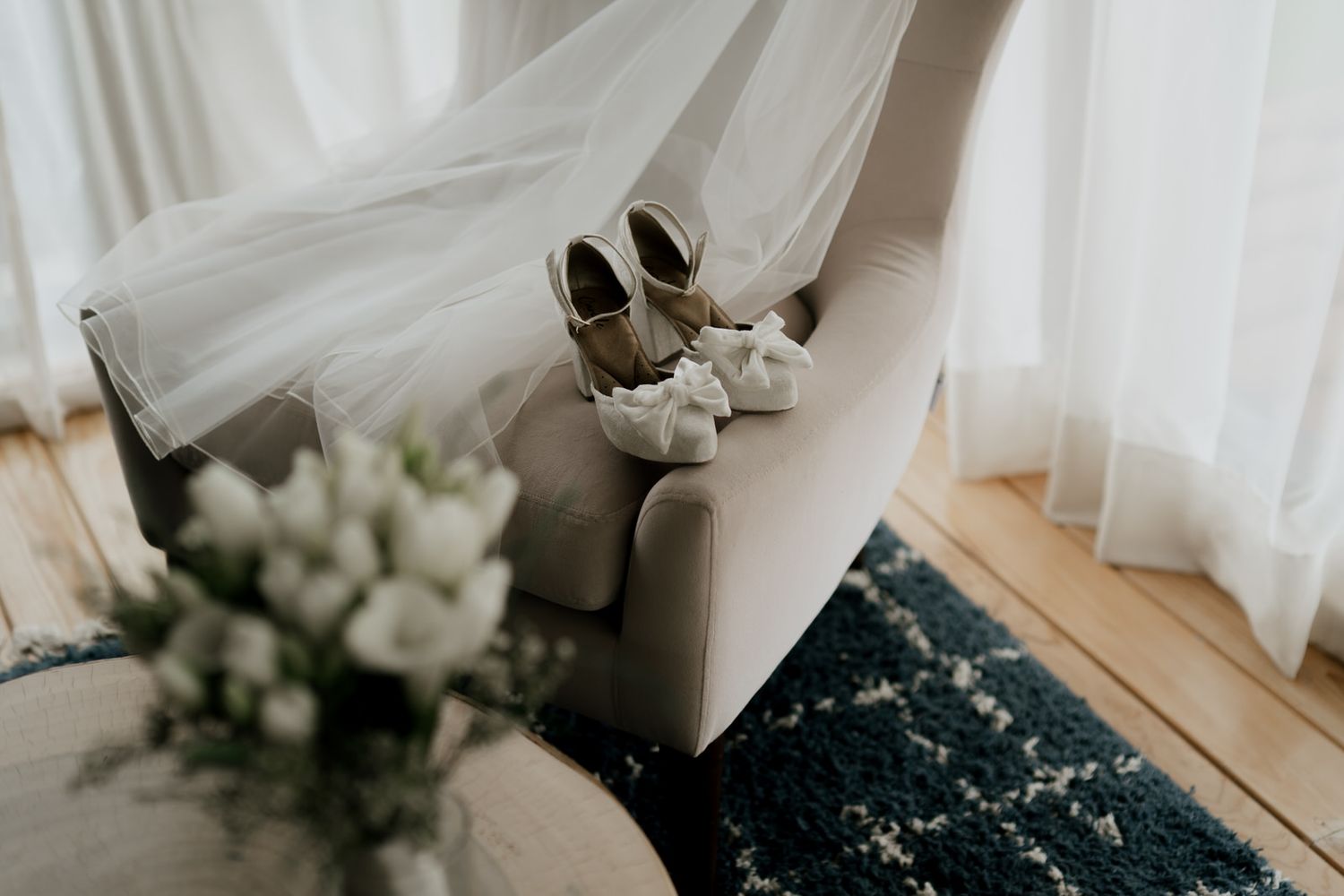White floral arrangements and decor details in elegant wedding setting.
