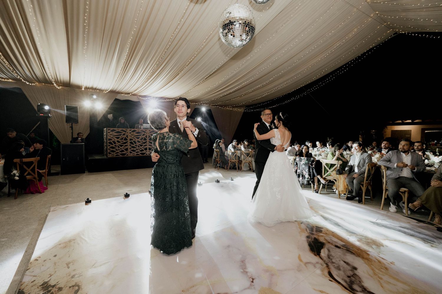 Wedding reception dance floor with dramatic lighting and fog effects.