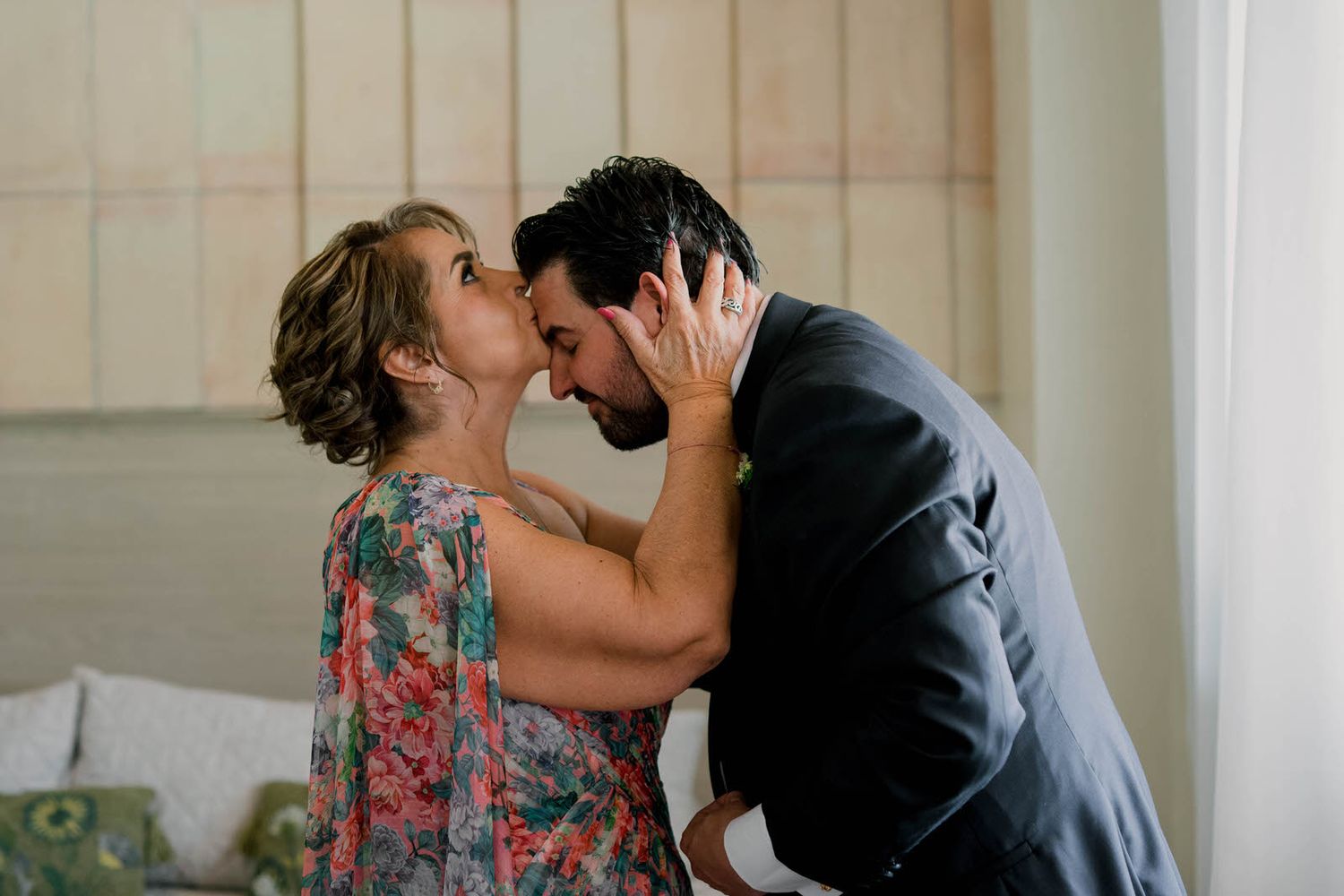 An intimate moment shared between two people in a warmly lit interior space.