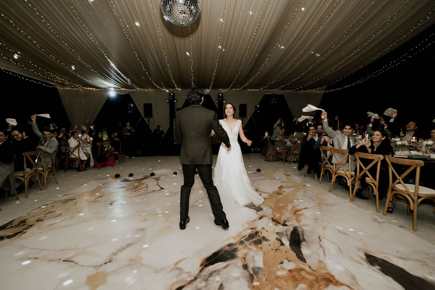 Wedding dance floor filled with fog and sparkler effects creating a dreamlike atmosphere.