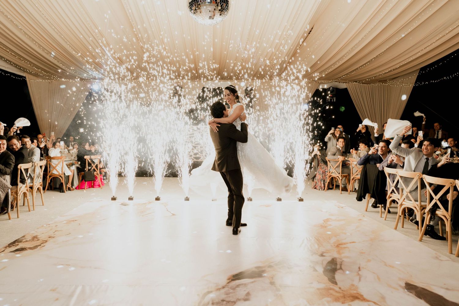 Wedding celebration with indoor pyrotechnics and fog effects creating a stunning visual display.