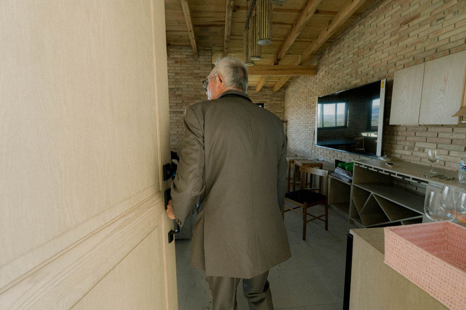 Long hallway view with exposed wooden ceiling beams and natural lighting.