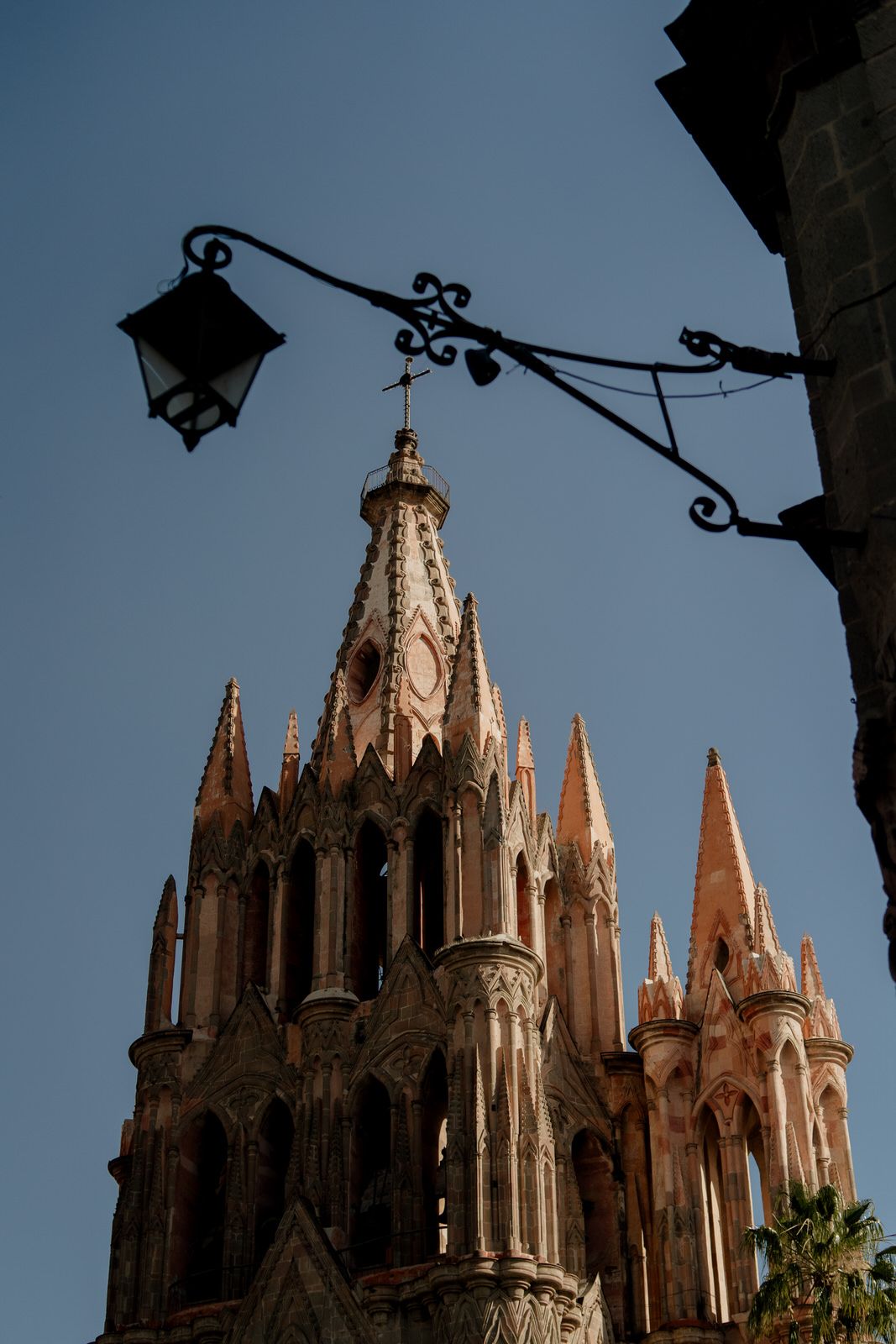 Gothic cathedral spires rise against a blue sky with ornate architectural details.