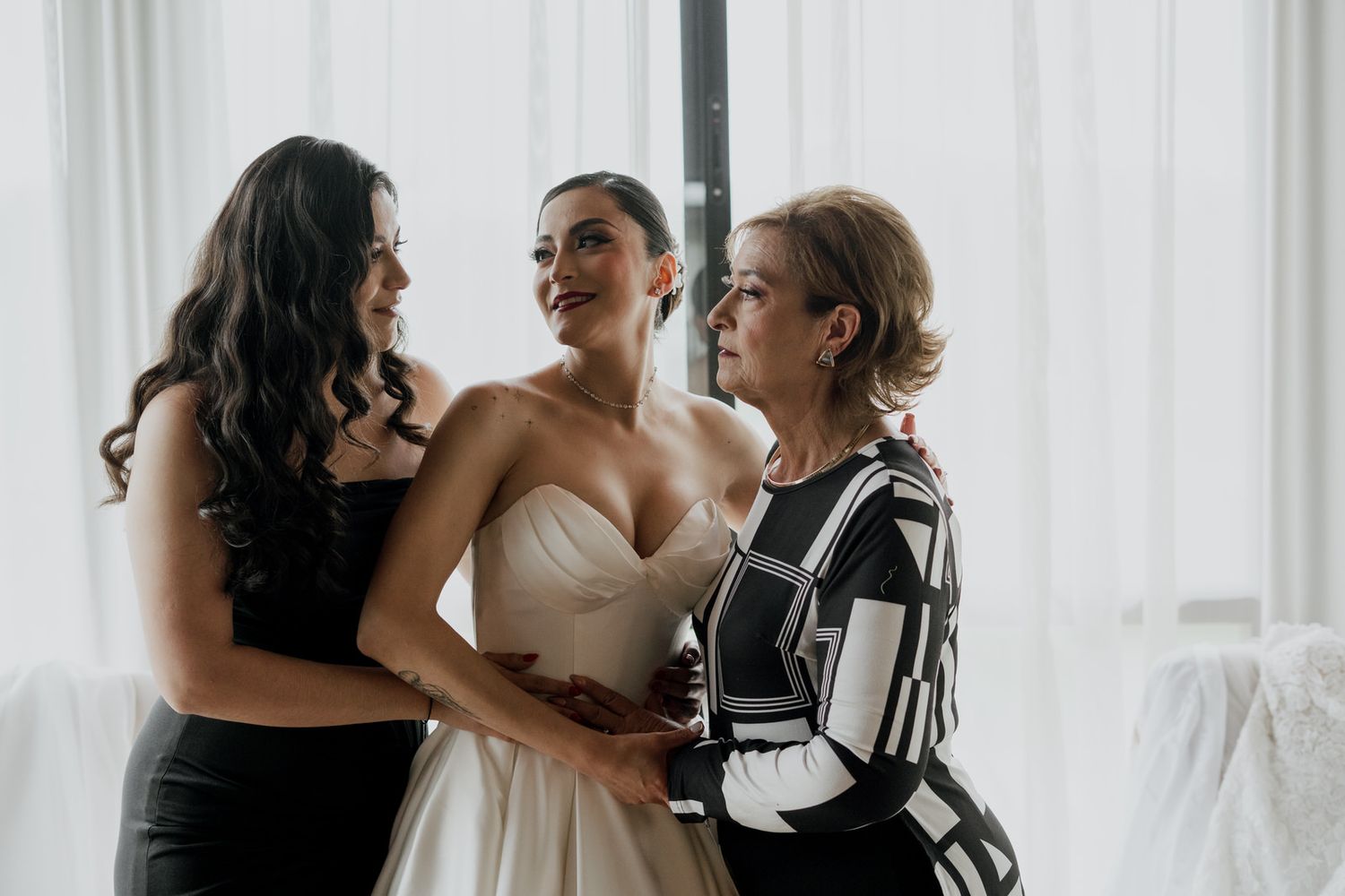 A joyful moment shared during wedding preparations in a bright room.