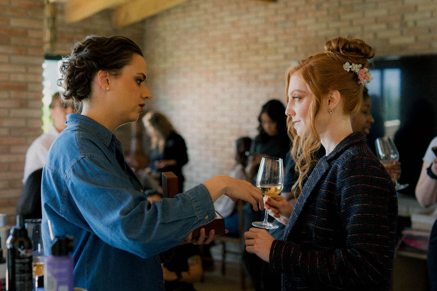 Group gathering in a brick-walled venue with natural lighting.