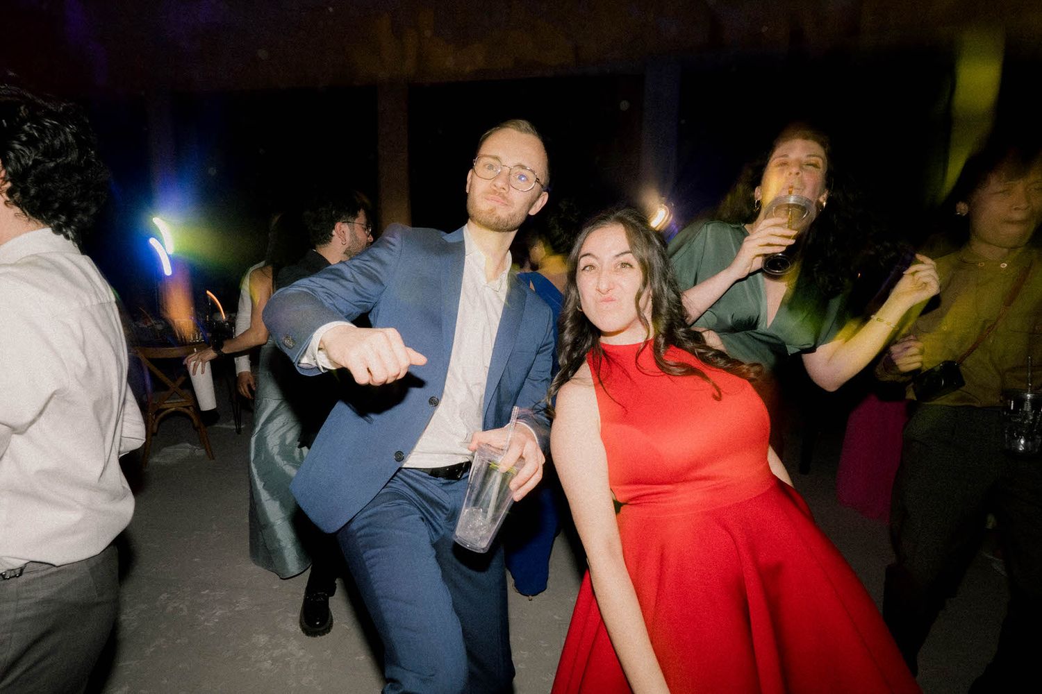 Energetic dance floor with people celebrating in colorful party attire.