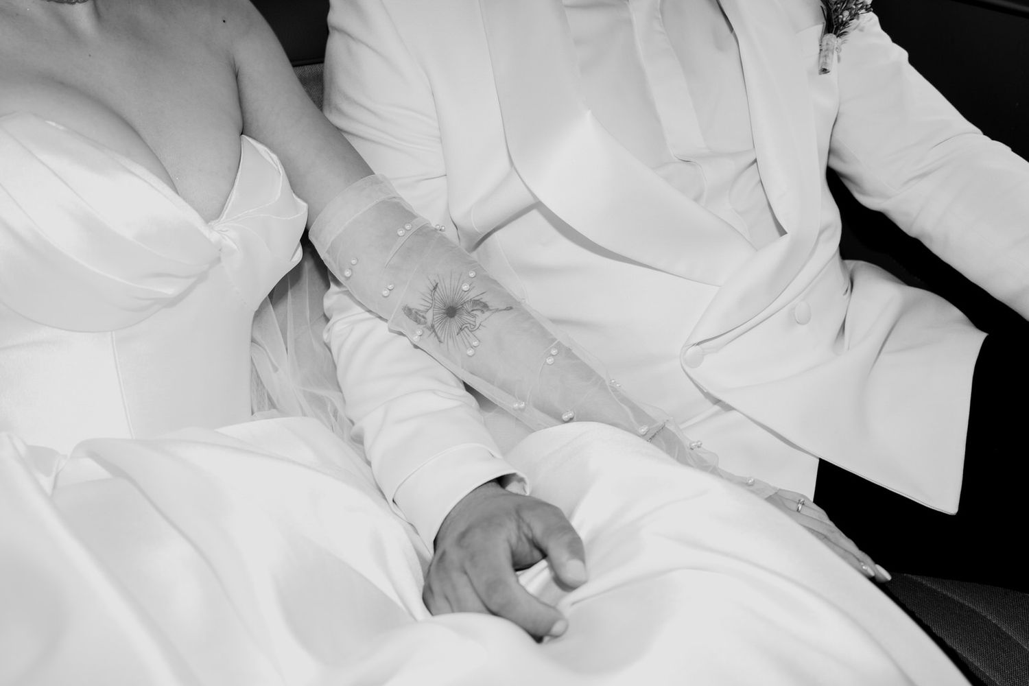 Wedding couple shares intimate moments in elegant white attire.