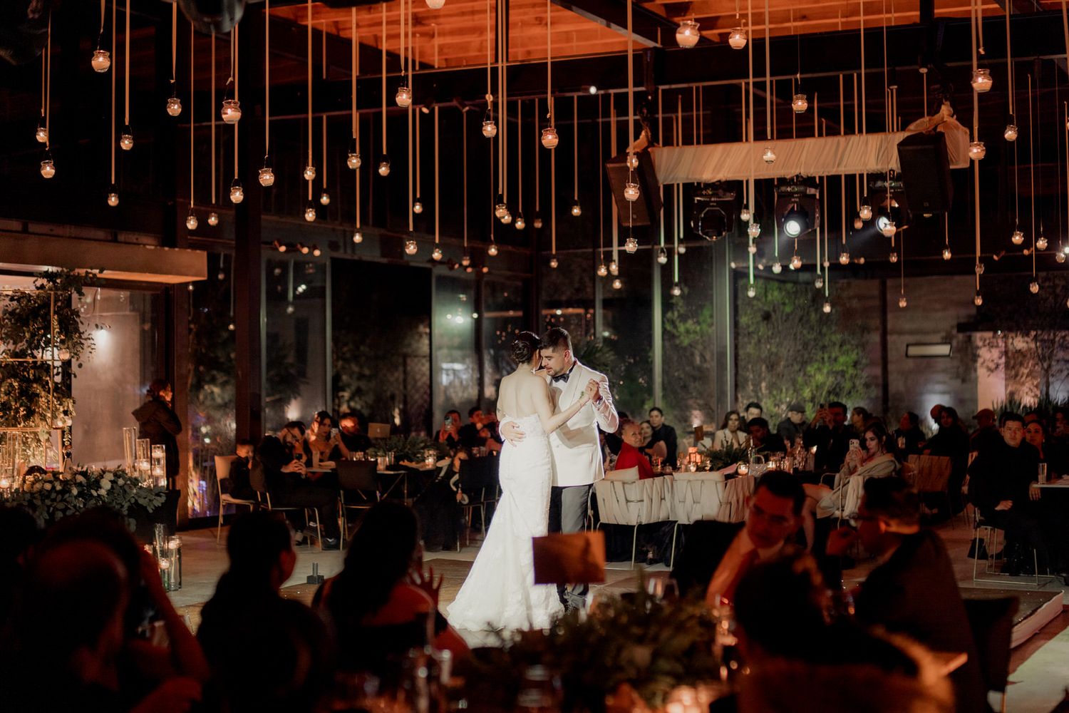 A romantic first dance scene with hanging lights and sparklers creating a dreamy ambiance.