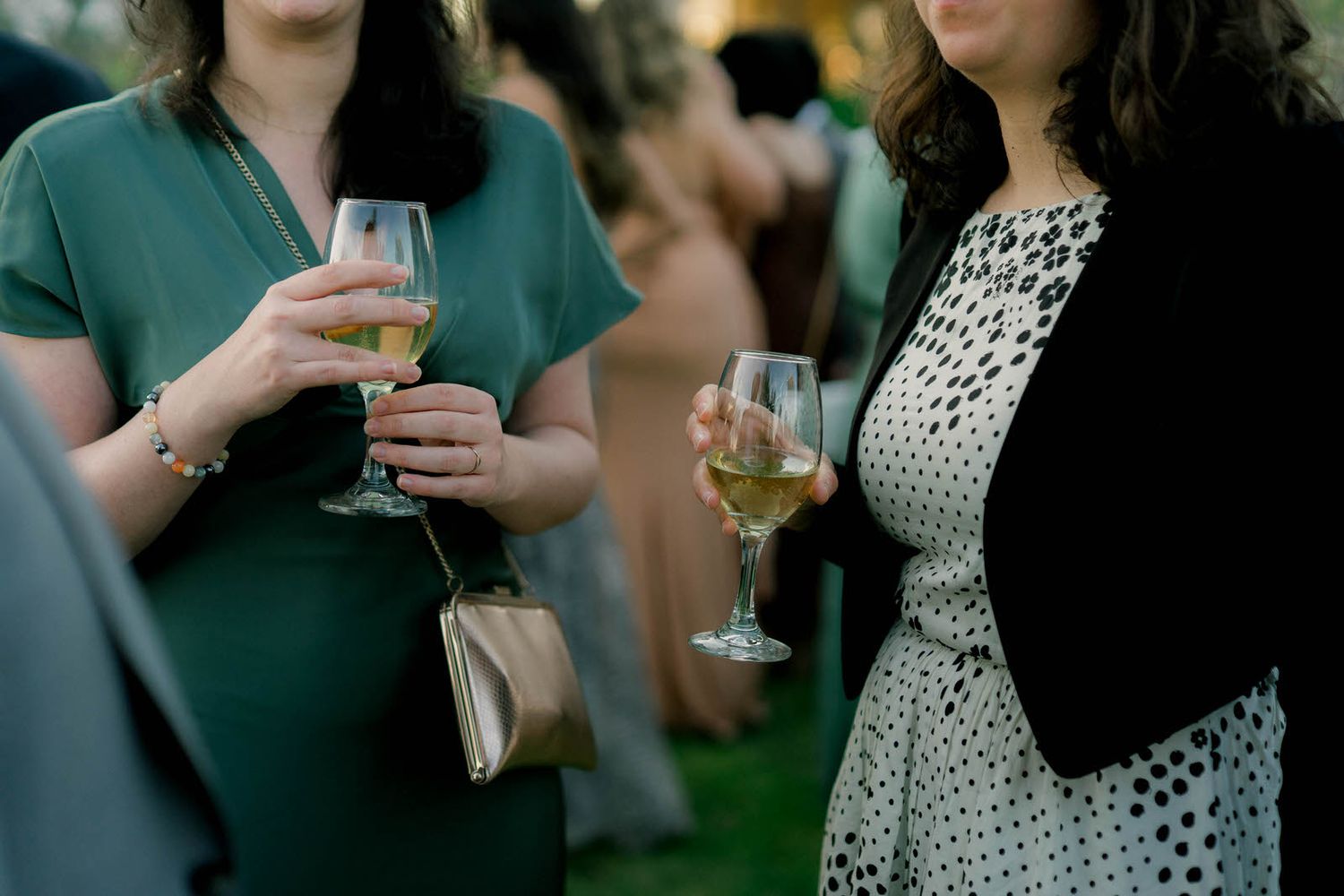 Guests enjoying drinks at an outdoor wedding reception.