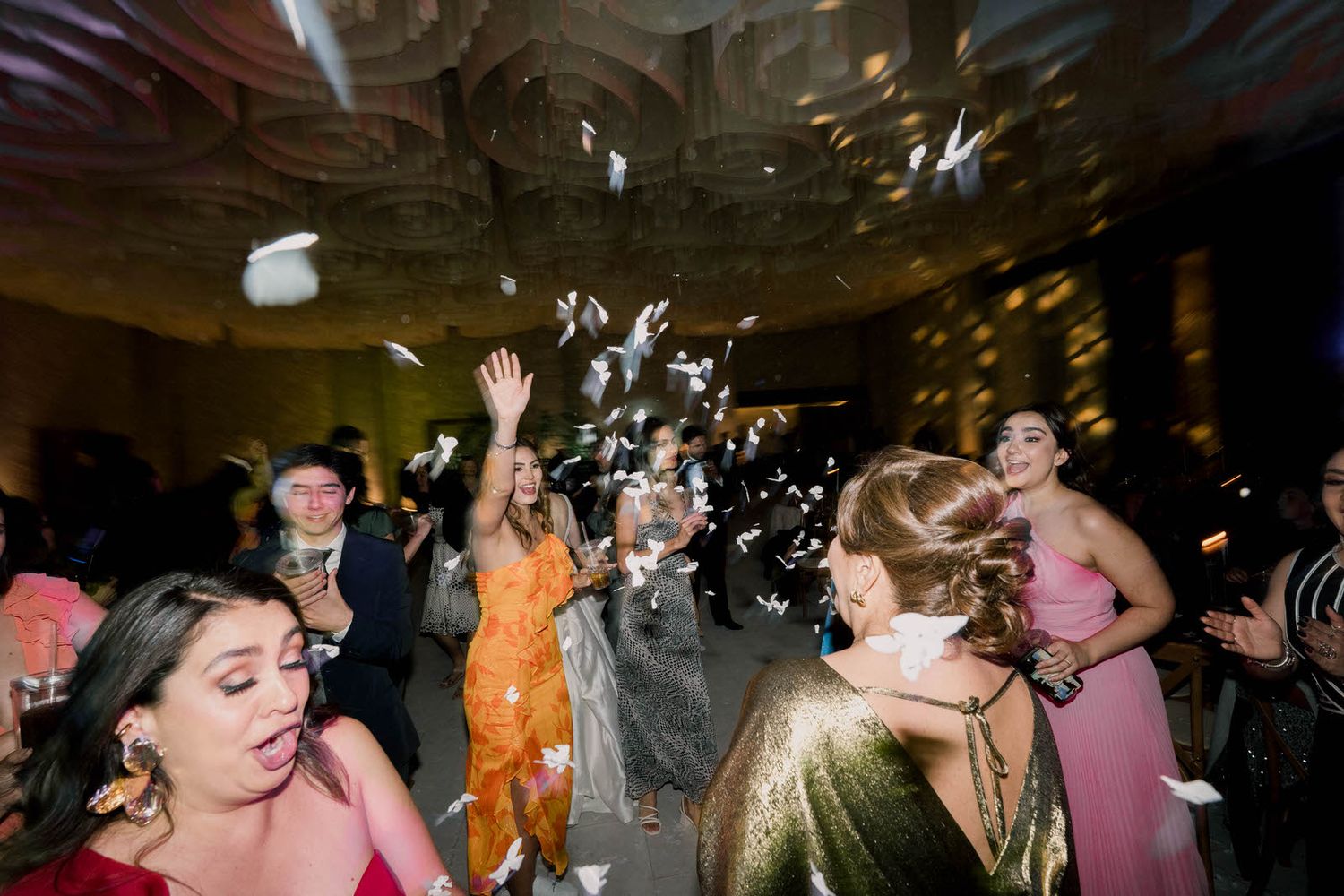 Celebration reaches peak excitement as confetti rains down on dancing party guests.
