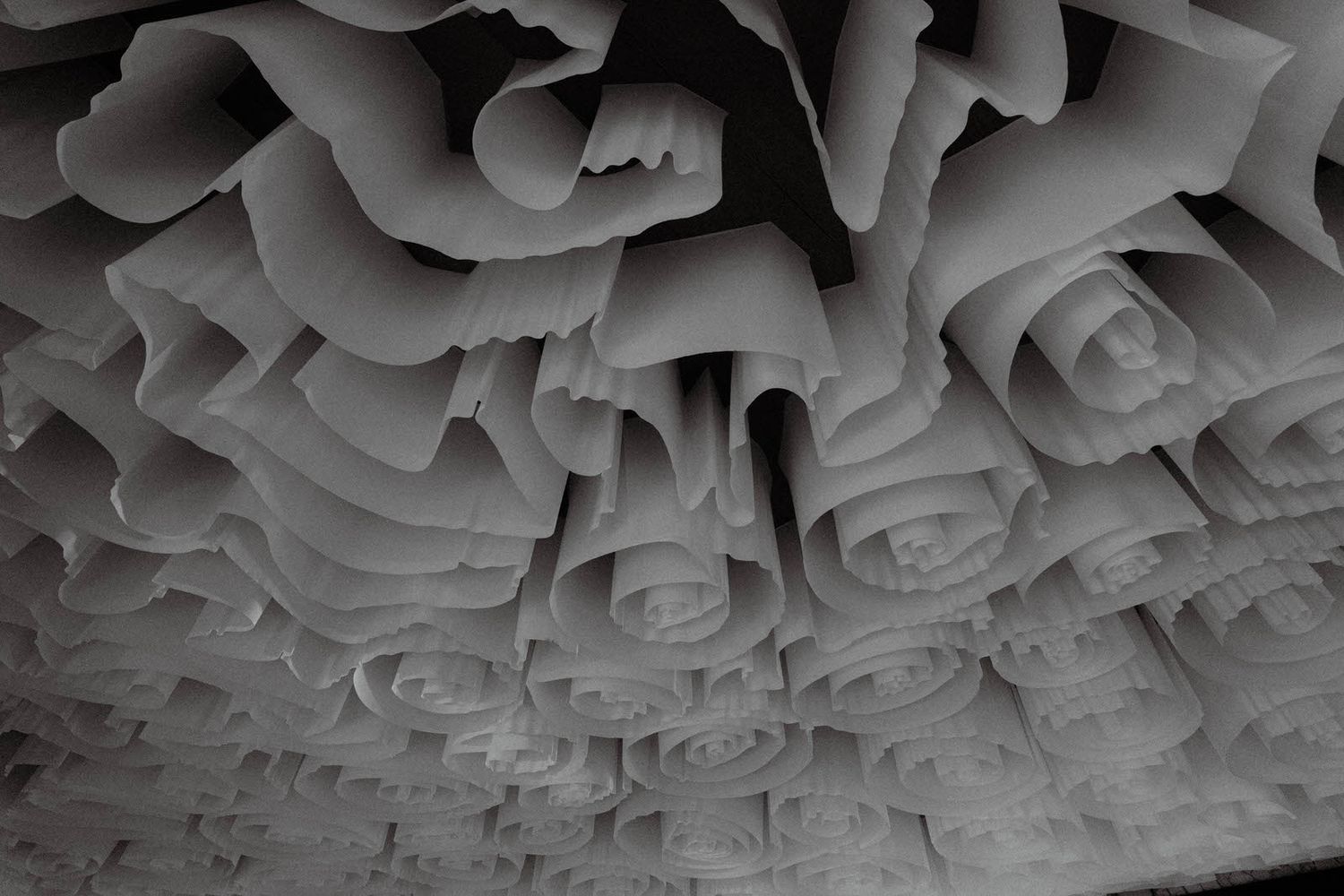 Detailed view of an ornate white textured ceiling with swirling patterns.