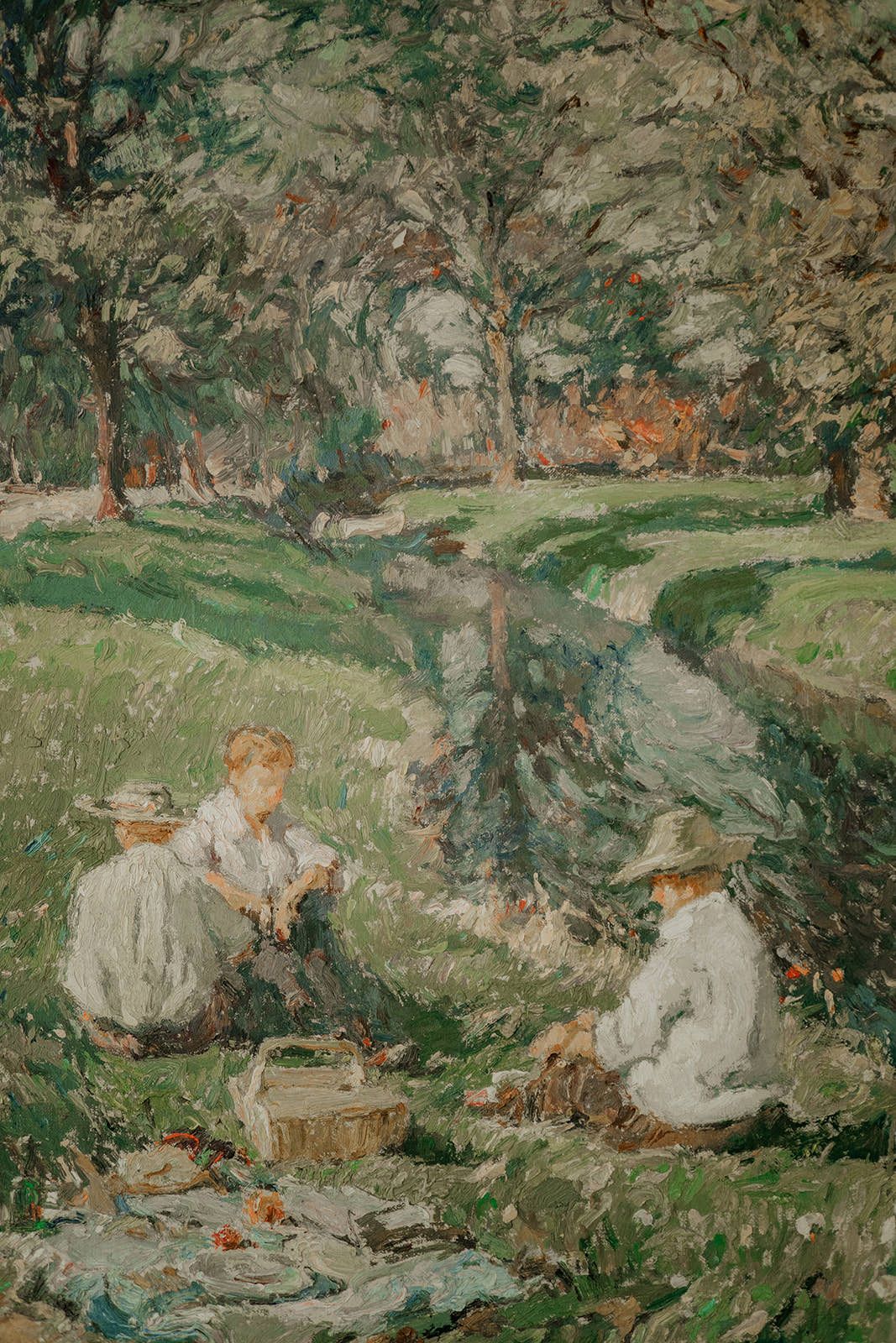 Impressionist painting depicting people lounging in a pastoral landscape with trees and rocks.