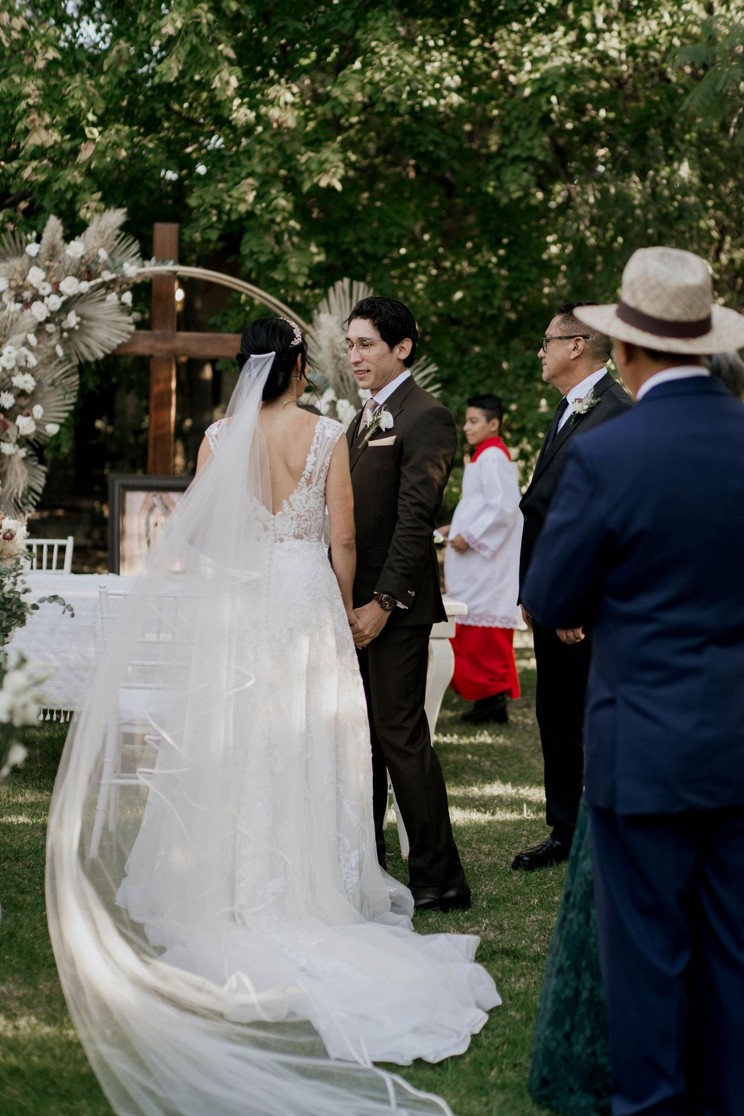 Flowing white wedding dress catches the breeze during an outdoor ceremony.