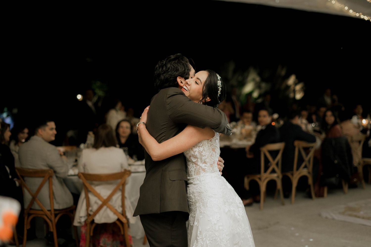 Elegant wedding reception venue with dramatic lighting and special effects during a dance.