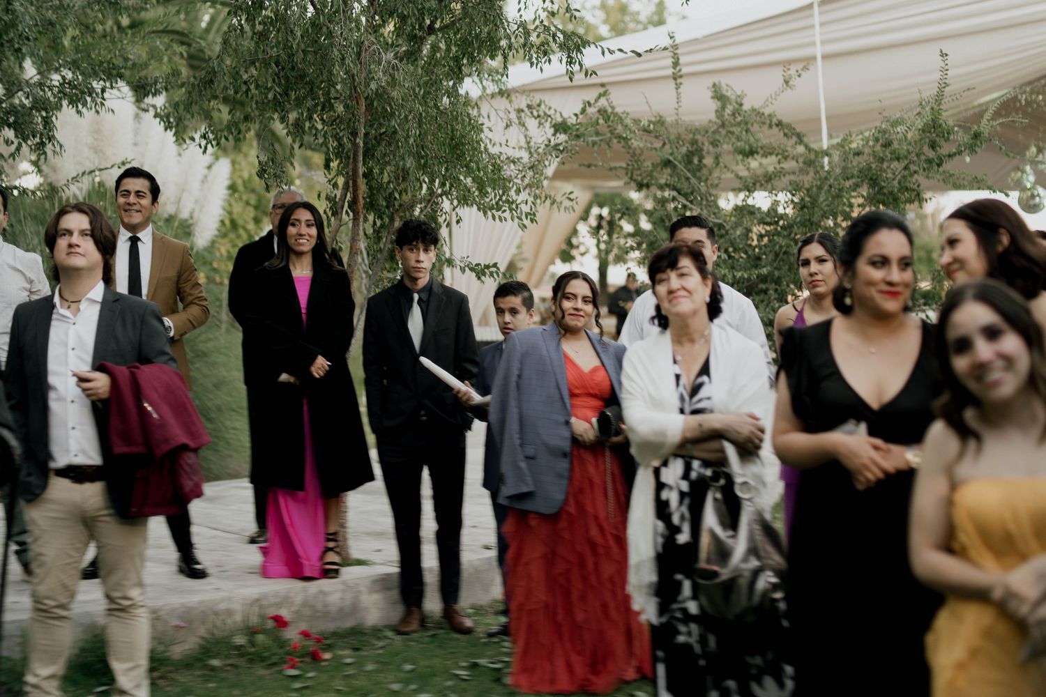 Wedding guests enjoying a festive outdoor celebration with colorful attire.