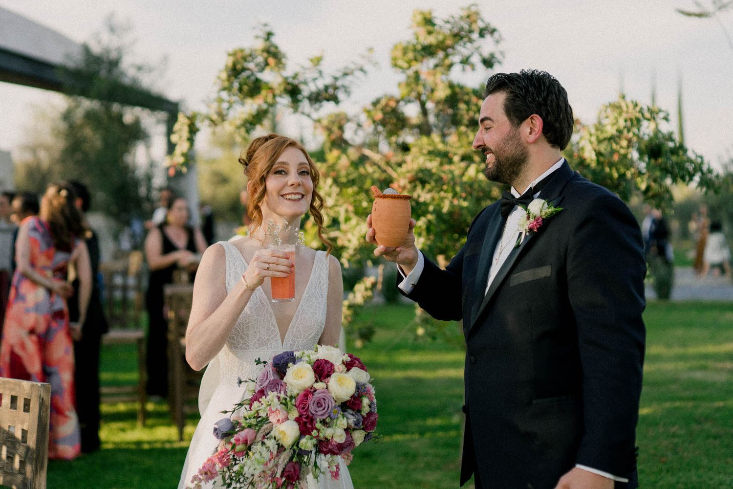 Elegant outdoor wedding ceremony with floral decorations in a garden setting.