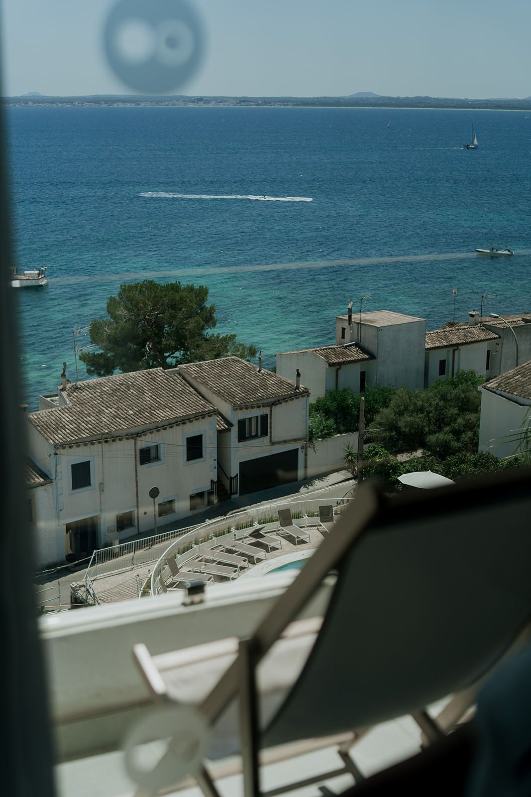Scenic Mediterranean coastal view with white buildings and blue ocean waters.
