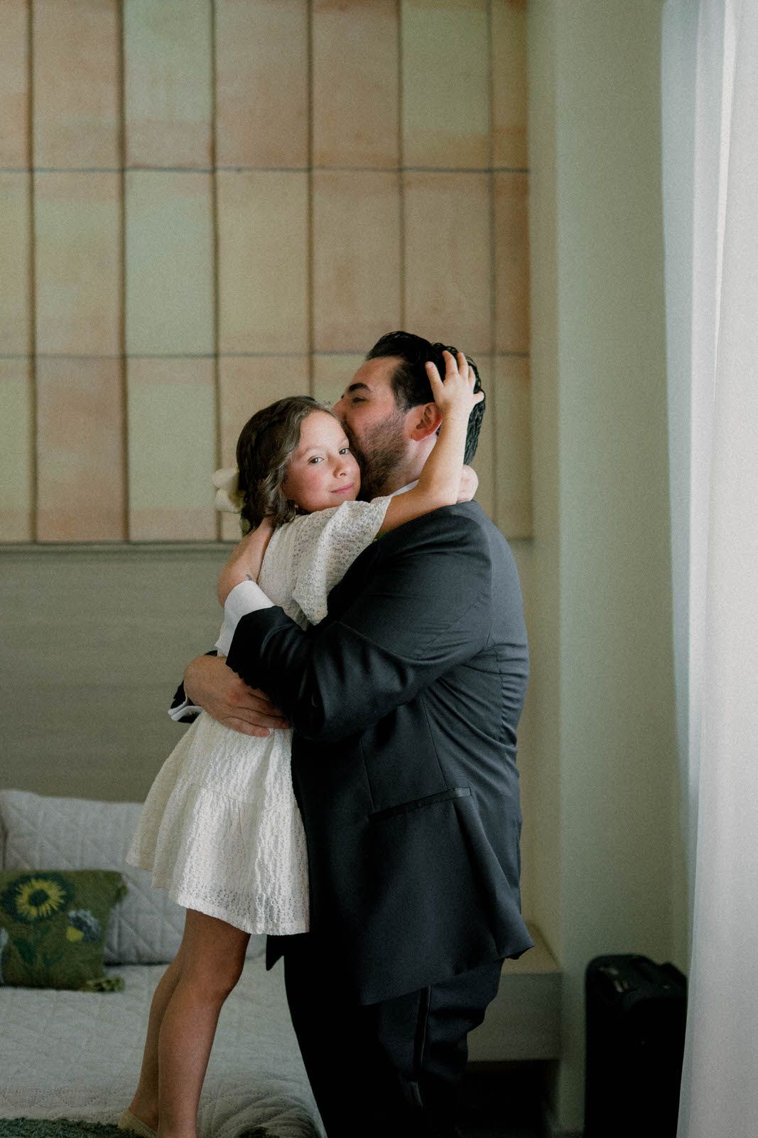 Emotional moments shared in a bright interior space with minimal decor.