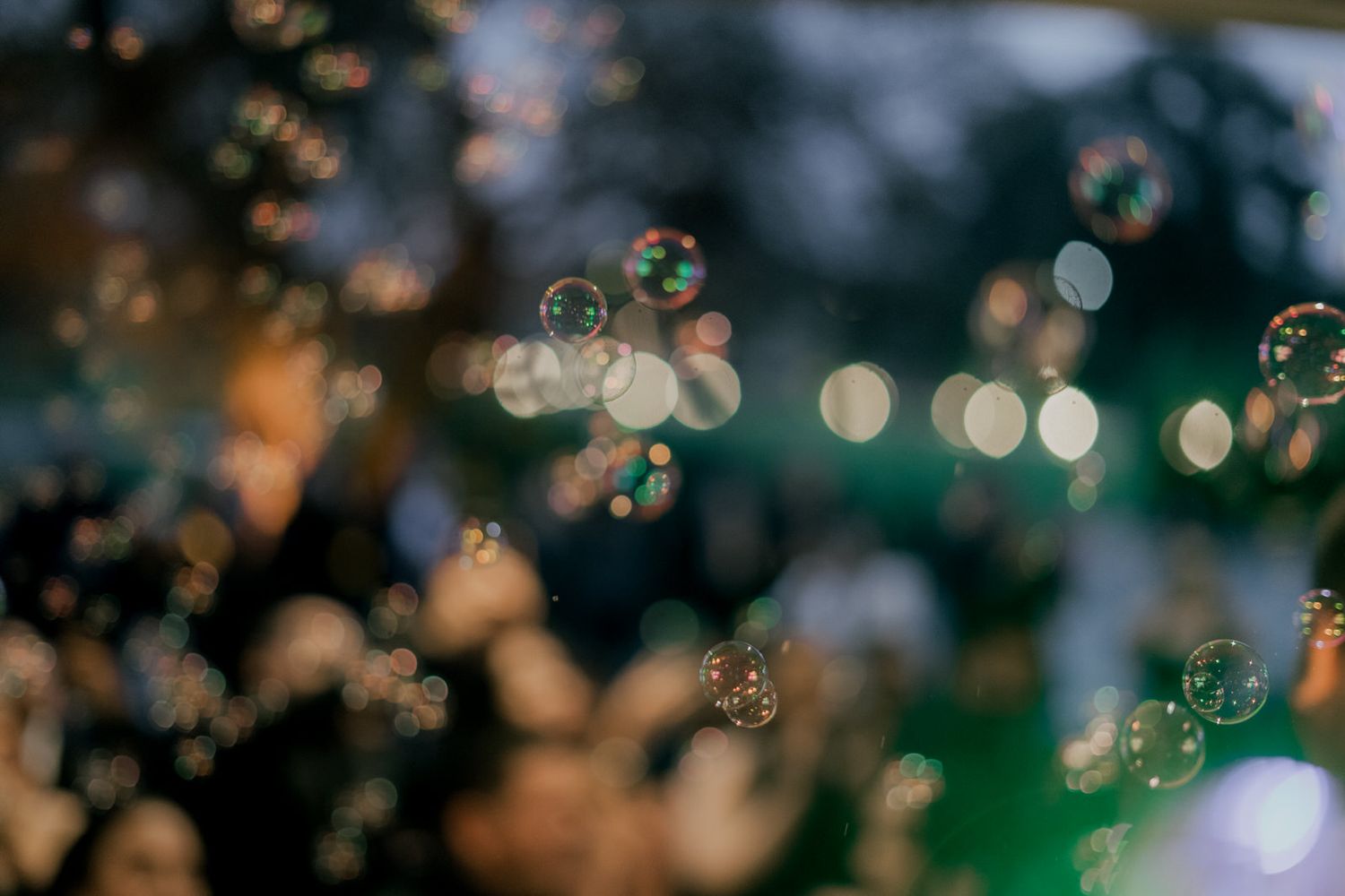 Blurred bokeh lights create a dreamy atmosphere at an evening celebration.