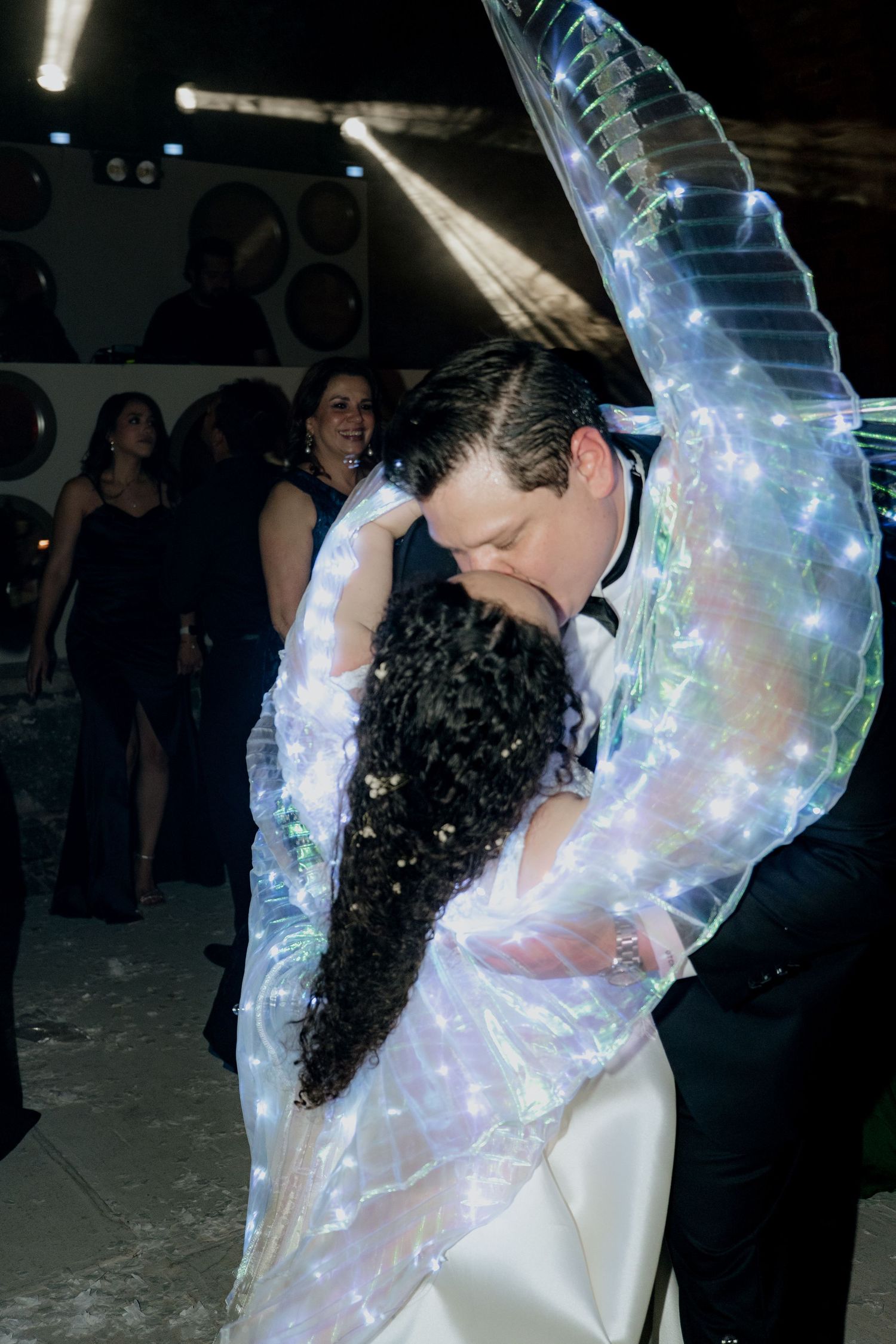 Romantic dance moment with illuminated veil creating a magical glow effect.