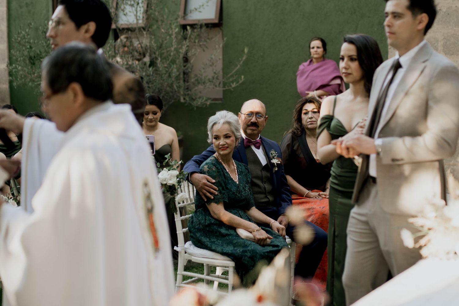 Wedding celebration with guests mingling in an outdoor garden setting.