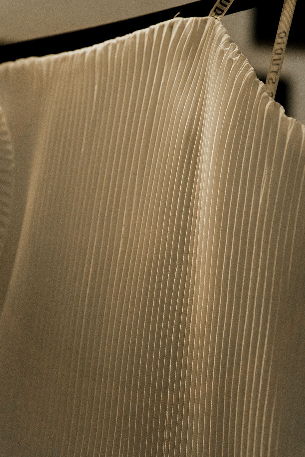 Abstract close-up of white vertical lines creating a minimalist pattern with subtle shadows.